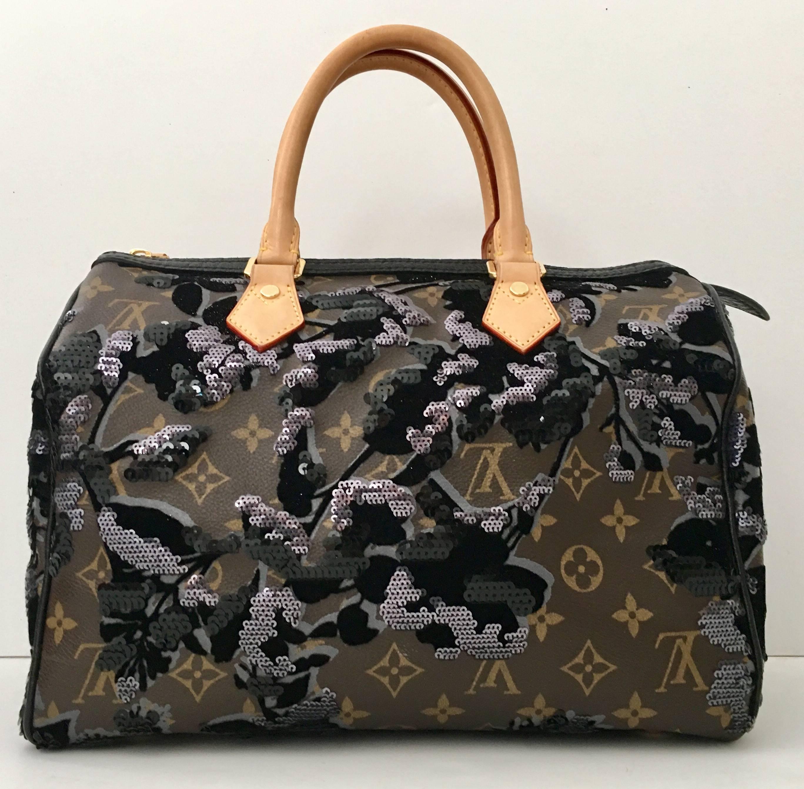  Louis Vuitton 2010-New Collectors Limited edition Monogram" Fleur De Jais" Speedy 35 handbag. Crafted from brown monogram coated canvas, this top handle bag satchel features a beautiful, ornate floral pattern with shimmering black and