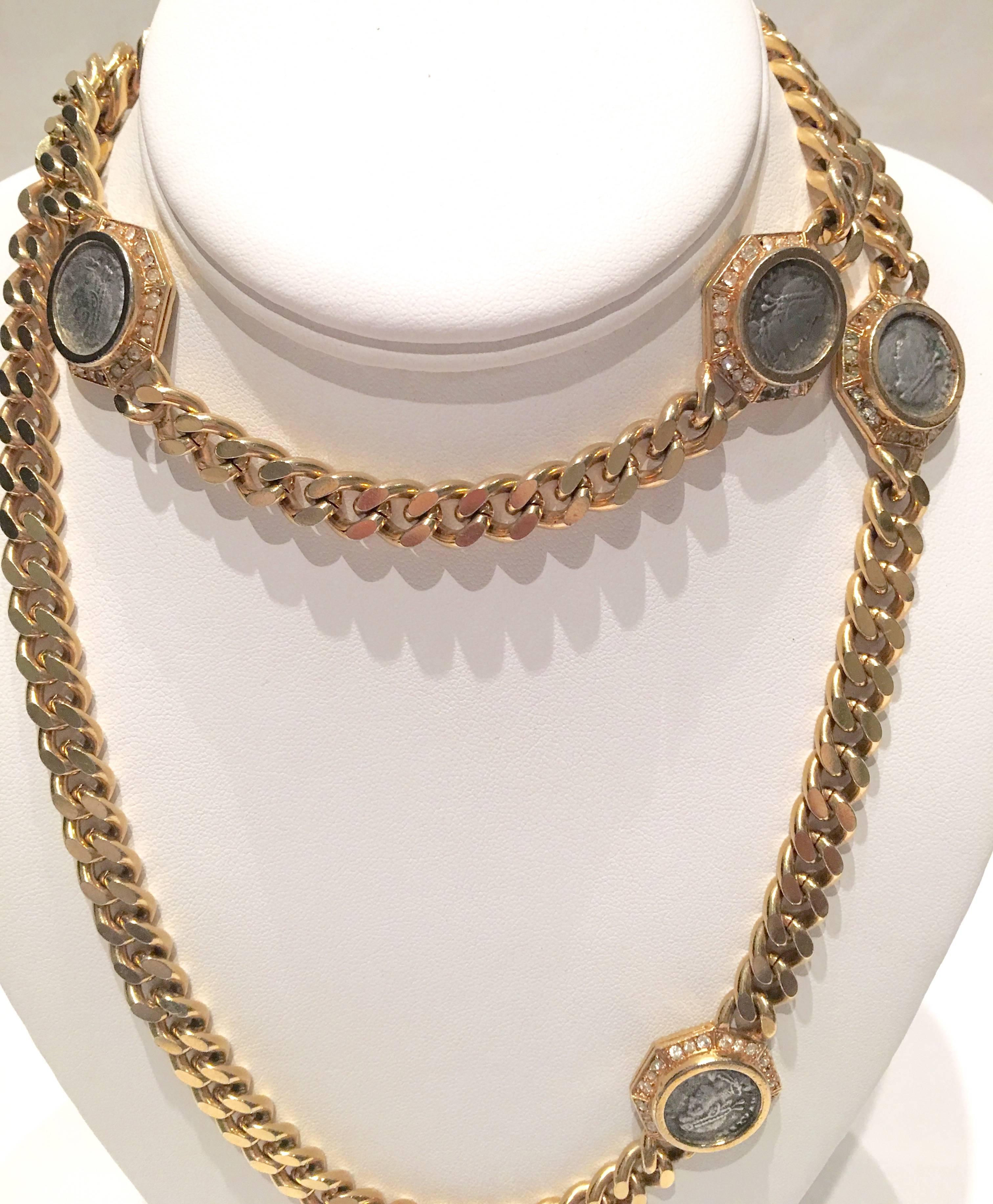 Rare Ciner opera length 18-karat yellow gold plated with faux roman coins in pewter surrounded by pave crystal rhinestones chain link rope necklace. Each of the four roman coins are surrounded by clear crystal rhinestones and measures, 1"