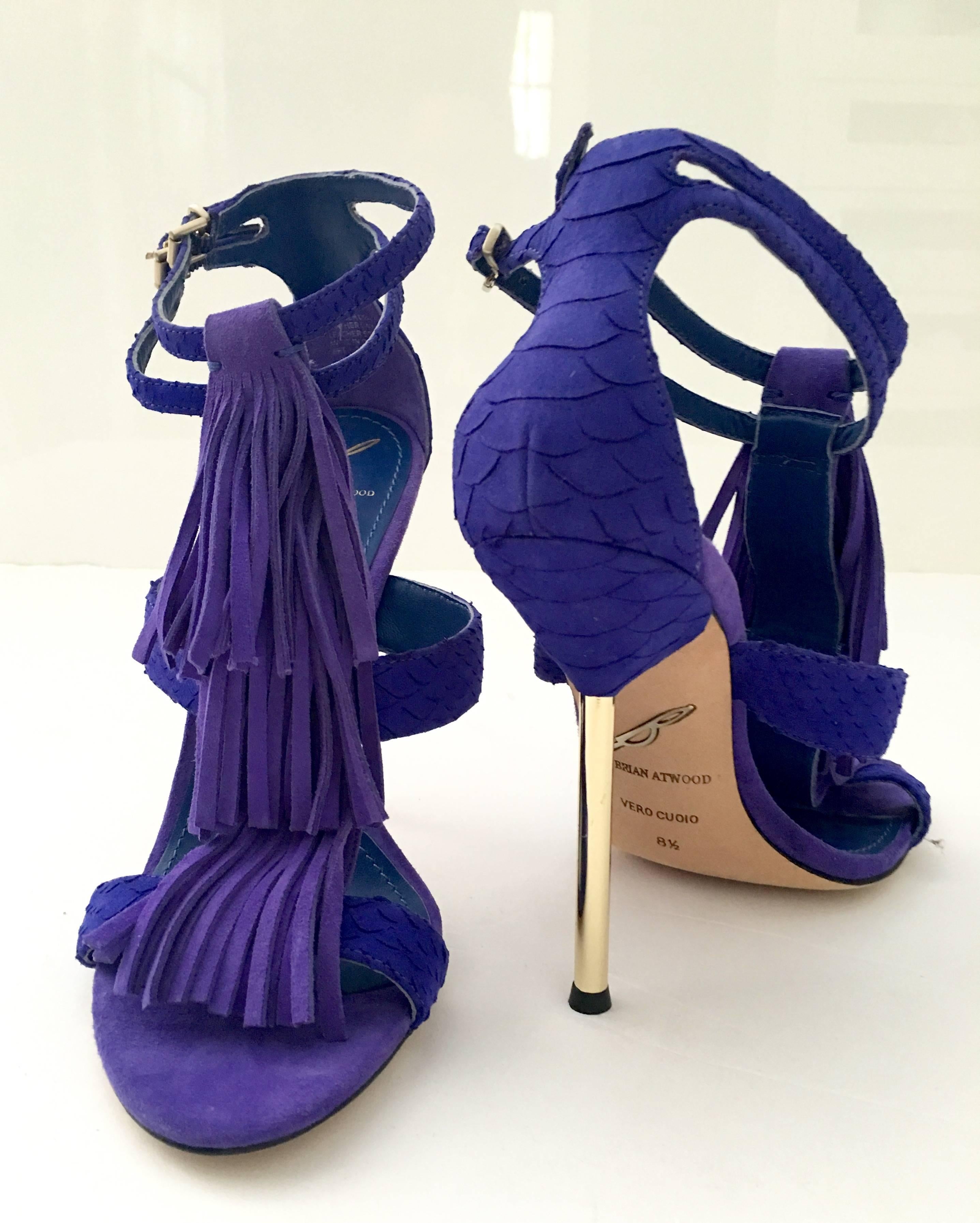Brian Atwood new, never worn, gold-tone metal heels and Dual buckle closures at ankle straps. Bright purple snake skin print fringe detail. Gold heels and hardware, heel is 4'5" high.
New-floor sample
