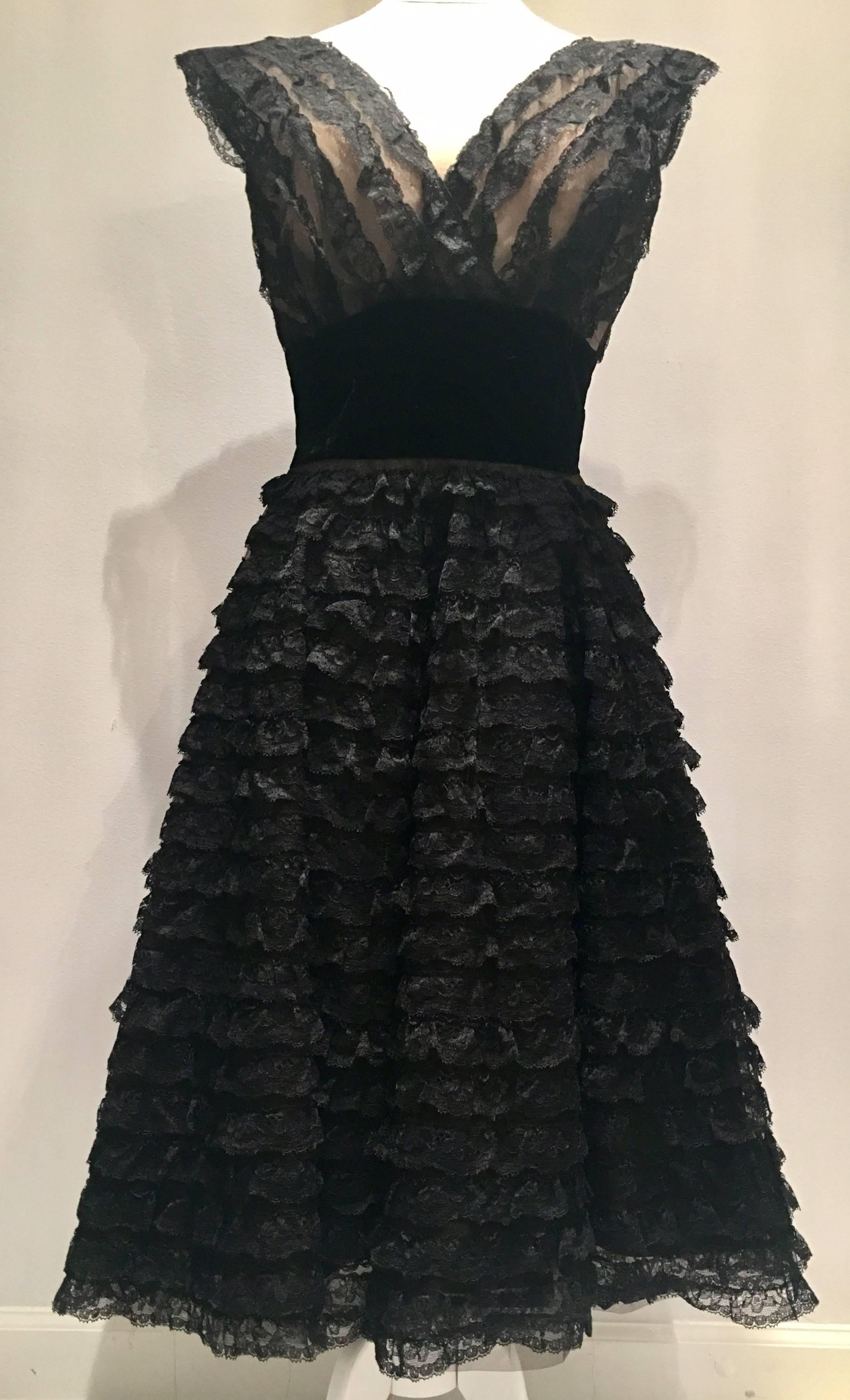 Extremely well crafted iconic 1950'S handmade black lace and velvet nude bodice pouf party dress. Skirt has a triple layer of lining, one in tulle to give it the "pouf" and style of the era. The bodice lining is a boned nude strapless