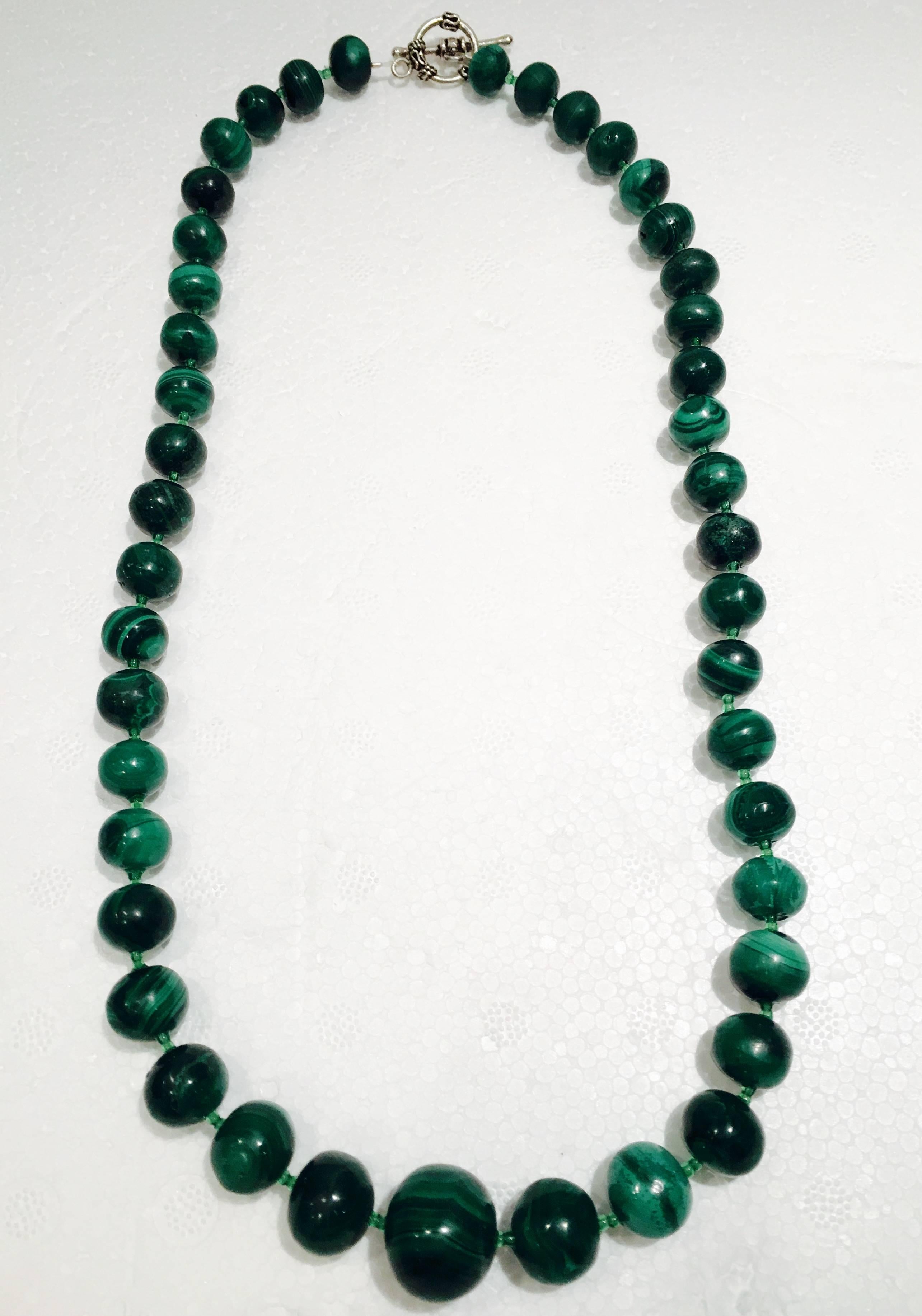 1970'S sterling silver and Malachite round bead necklace. Necklace consists of 44 beads in total and graduate in size. Center stone is 2