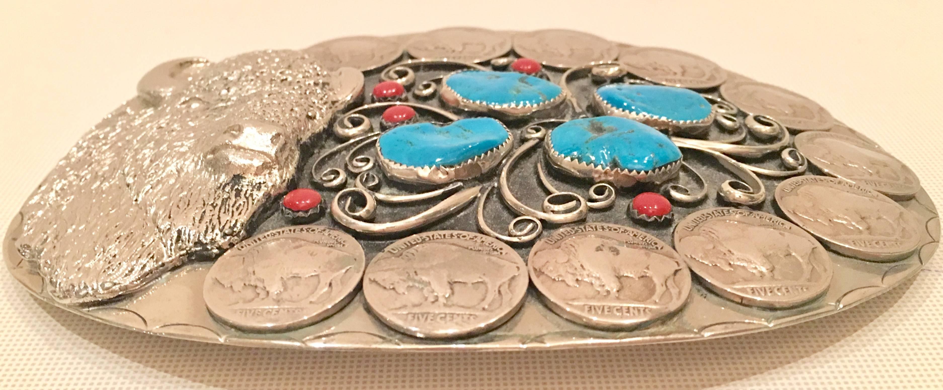 Mid-Century Monumental Buffalo sterling silver and nickel silver belt buckle. This signed squaw wrap belt buckle features four large authentic turquoise stones and five coral stones, surrounded by eleven nickel silver buffalo nickel coins and a