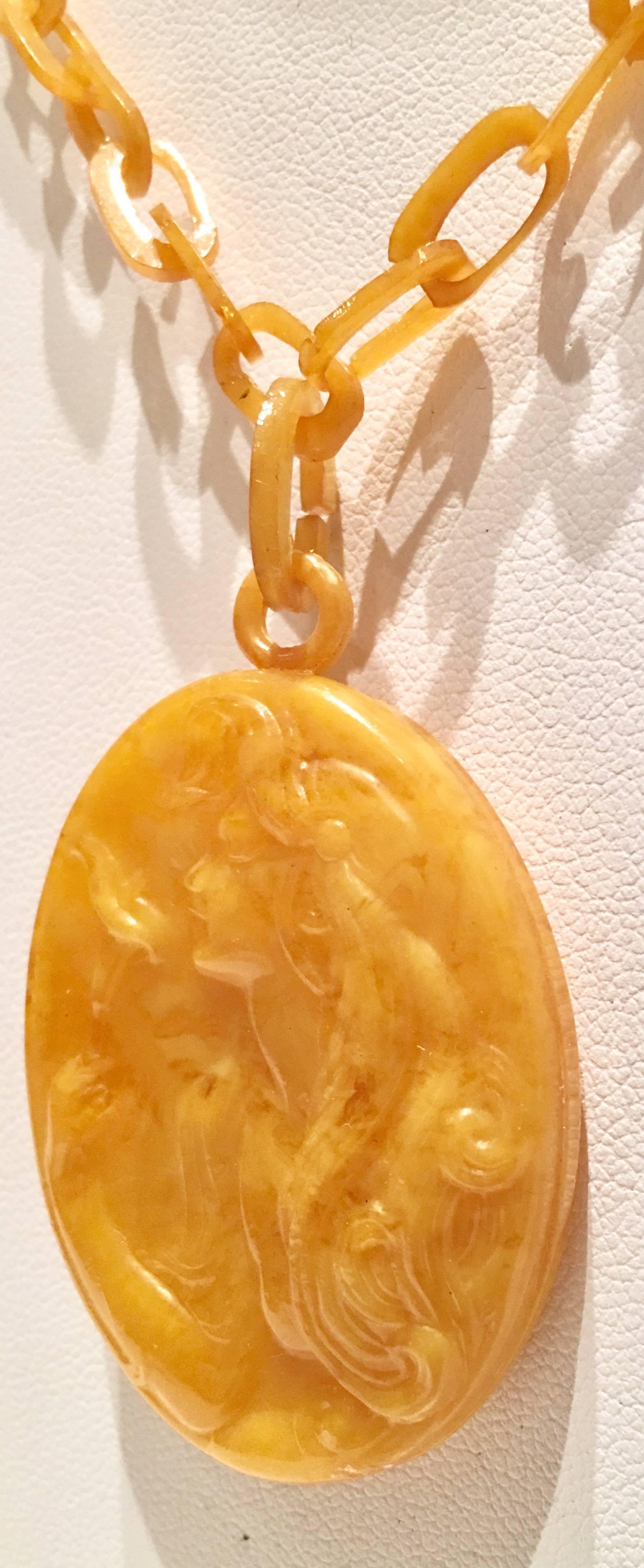 Art Nouveau Bakelite & Celluloid Carved High Relief Cameo Chain Link Pendant Necklace. The double sided pendant, features a butterscotch Bakelite double sided carved high relief female with flowing hair, holding a flower. The necklace is made of