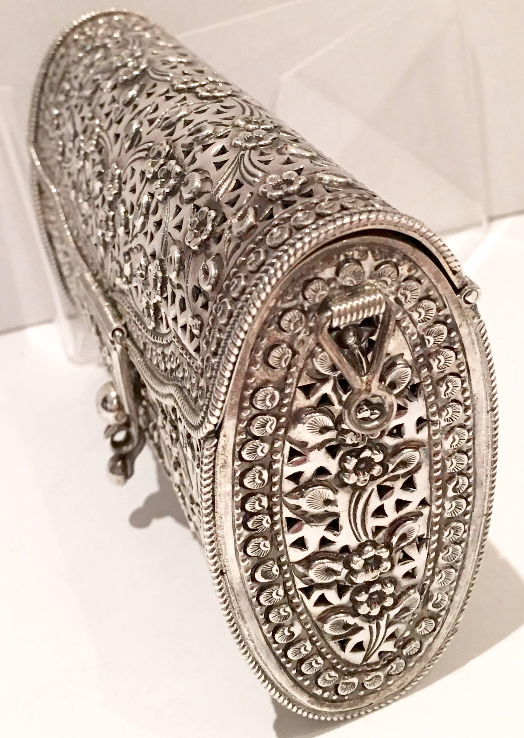 Vintage sterling 925 marked floral filigree silver work minaudiere handbag with detachable silver chain. Beaded detail throughout with beautiful etched detail on the bottom. Shoulder strap is optional and measures, 42" inches in length.
Signed
