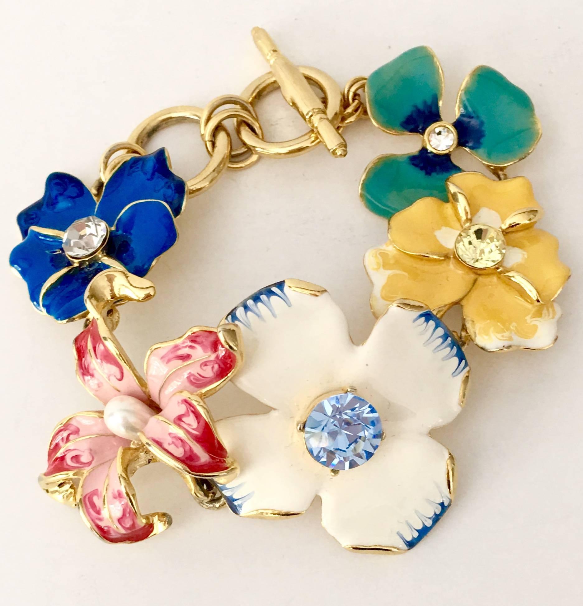 Kenneth Lane enamel, Swarovski crystal and gold plate toggle bracelet. Signed on the toggle and underside, Kenneth Lane. Five vibrant colored flowers and gold plate chain link make up this "happy" piece from famed jeweler, Kenneth Jay Lane.
