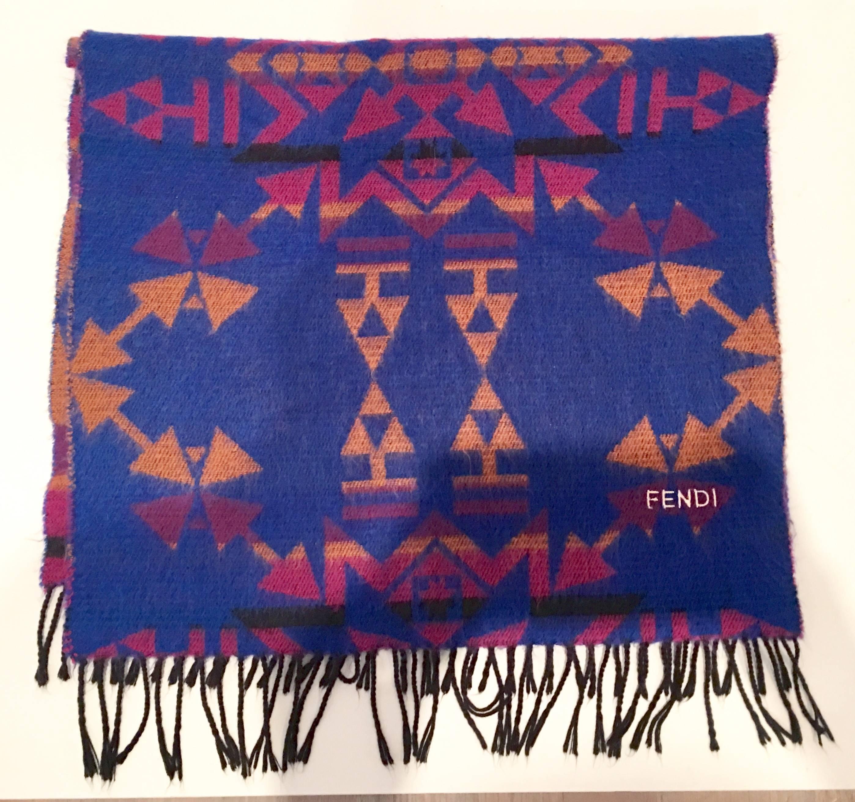 Stunning and vibrant lapis purple, orange, fuchsia, and black with black fringe and gold metallic Fendi logo throw or shawl. Fendi manufacturing tag intact. Made In Italy.Feels like cashmere.