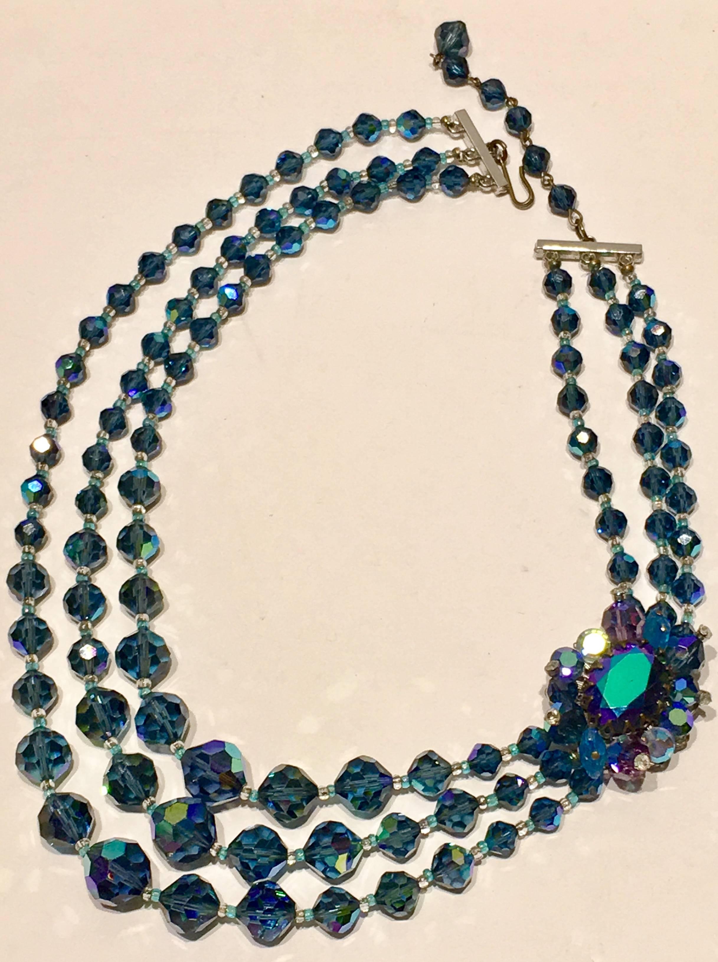 1950'S Peacock Blue Aurora Borealis Faceted Art Glass Bead Triple Strand Choker necklace. This sparking stunner features and off center cabochon cut large Aurora borealis glass center stone, prong set and backed in silver plated metal. The