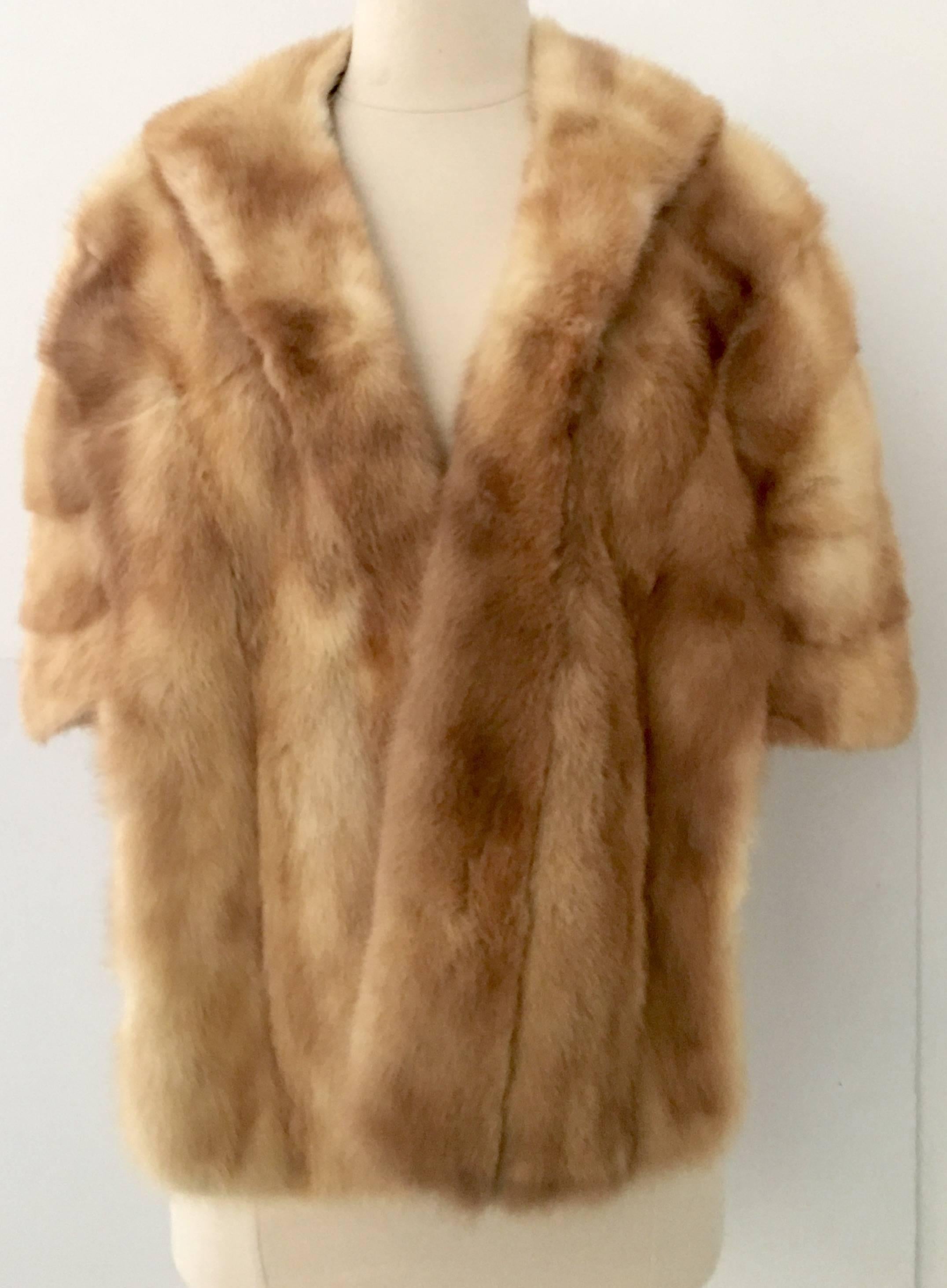 1940'S Mink Fur Capelet Jacket By Harry Kanfer Furs. This luxurious blonde mink fur jacket or cape let features 2 side slit pockets and is fully lined with the furrier tag in tact in the pristine lining. One size fits all.
Shoulder to shoulder