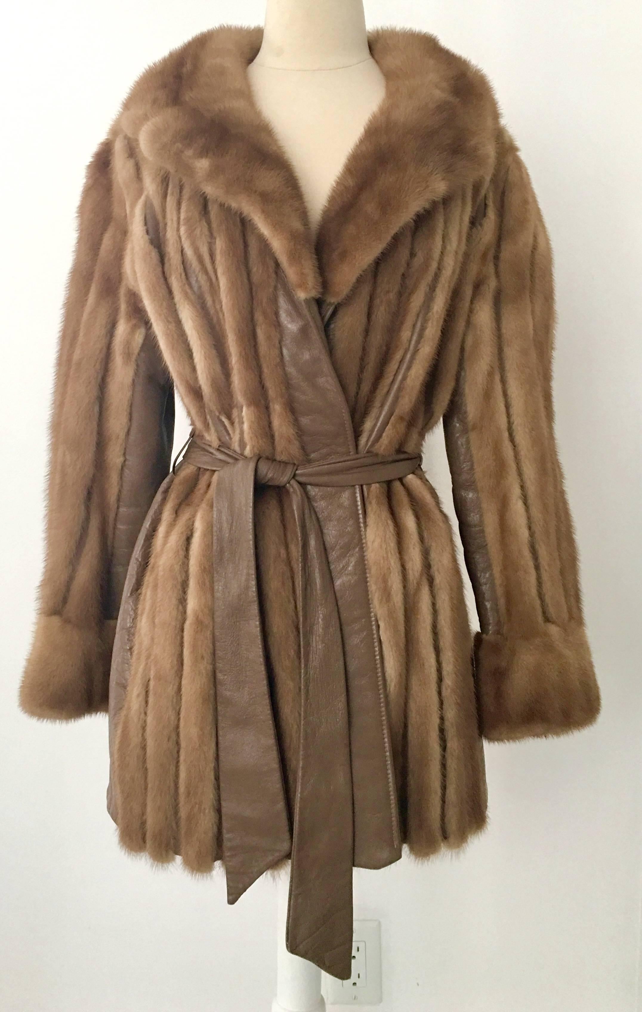 MOD 1970'S Mink & Leather belted panel coat. Rich, silky and luxurious this sleek and timeless coat will keep you warm, stylish and yet it is lightweight .Features a fully lined interior, two front side pockets and the original looped leather belt.