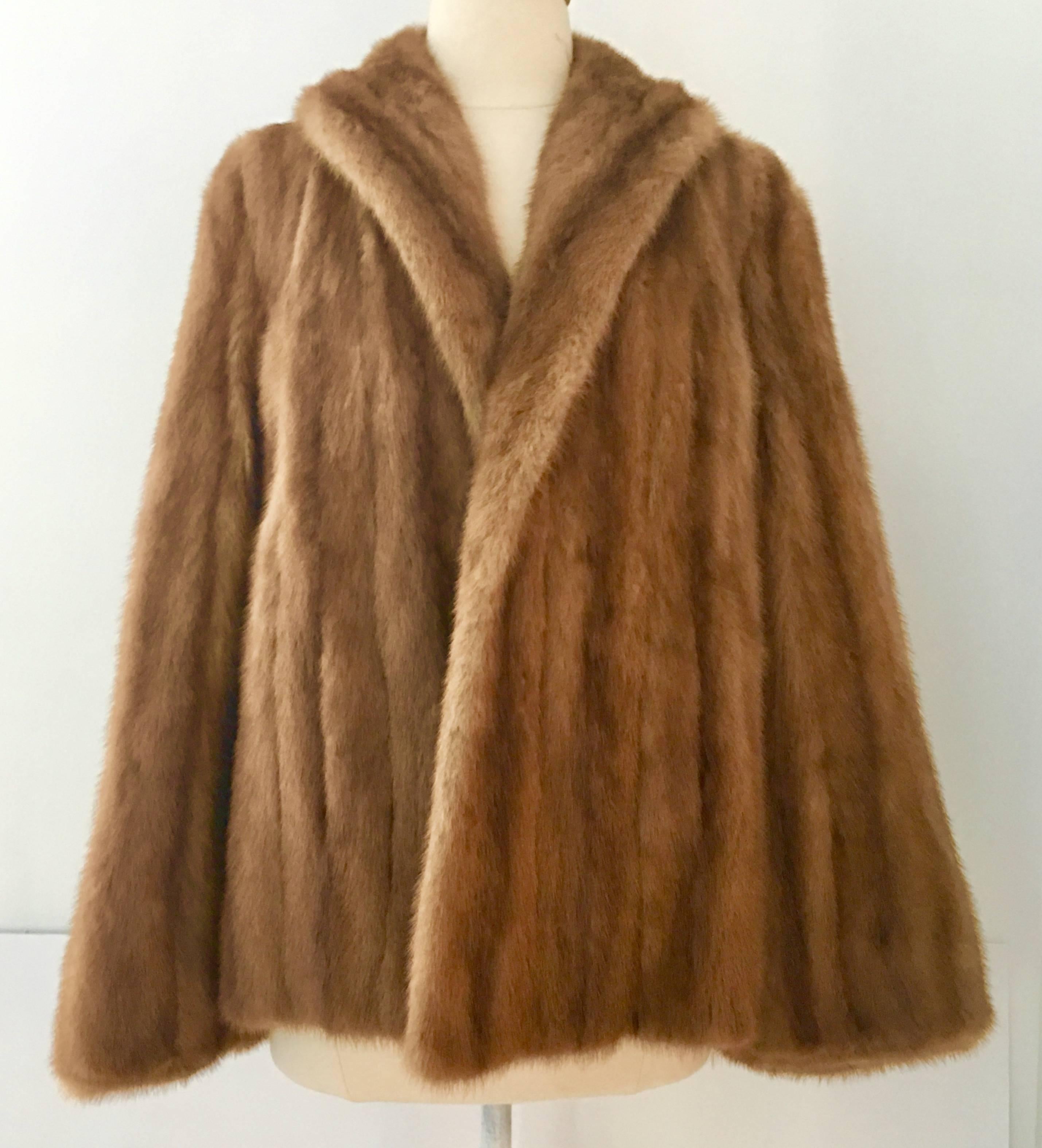 Gorgeous Mid-Century whiskey dyed mink fur swing jacket with wide bell sleeves. Fully lined coat with two front side pockets. Fits like a women's medium, chest is 20" from armpit to armpit, sleeves are 24.5" shoulder to end of sleeve