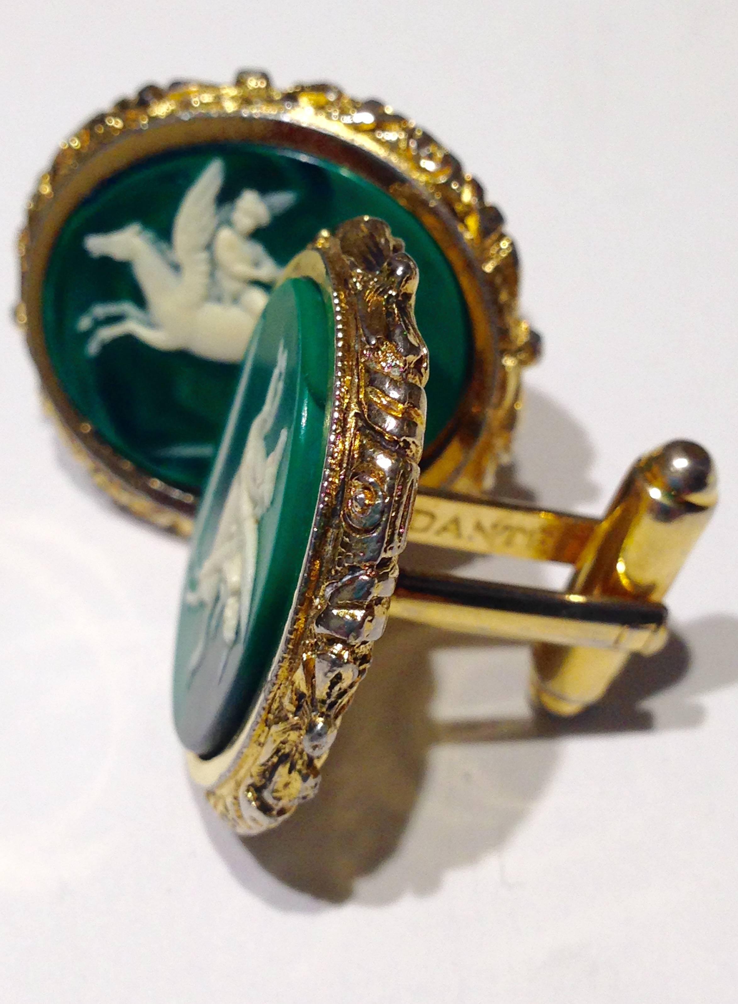 Emerald and ivory Incolay stone carved cameo Pegasus set in gold plated oval cufflinks. This pair of mythological Pegasus cuff links are part of the 1960s museum masterpiece collection produced in the each cuff link is signed, Dante.