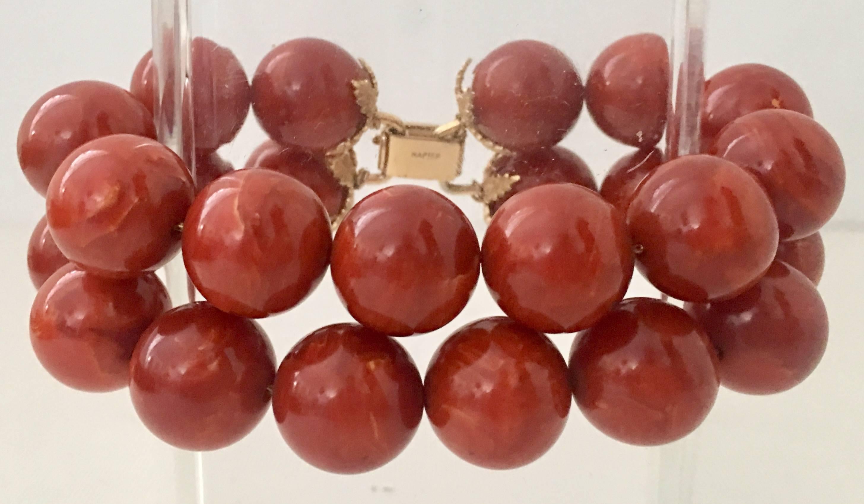 Vintage Cinnamon Bakelite Double Row Bead Bracelet By, Napier. Features a gold plate organic leaf detail and classic box clasp. The clasp is signed, Napier.
Beads are approximately .50