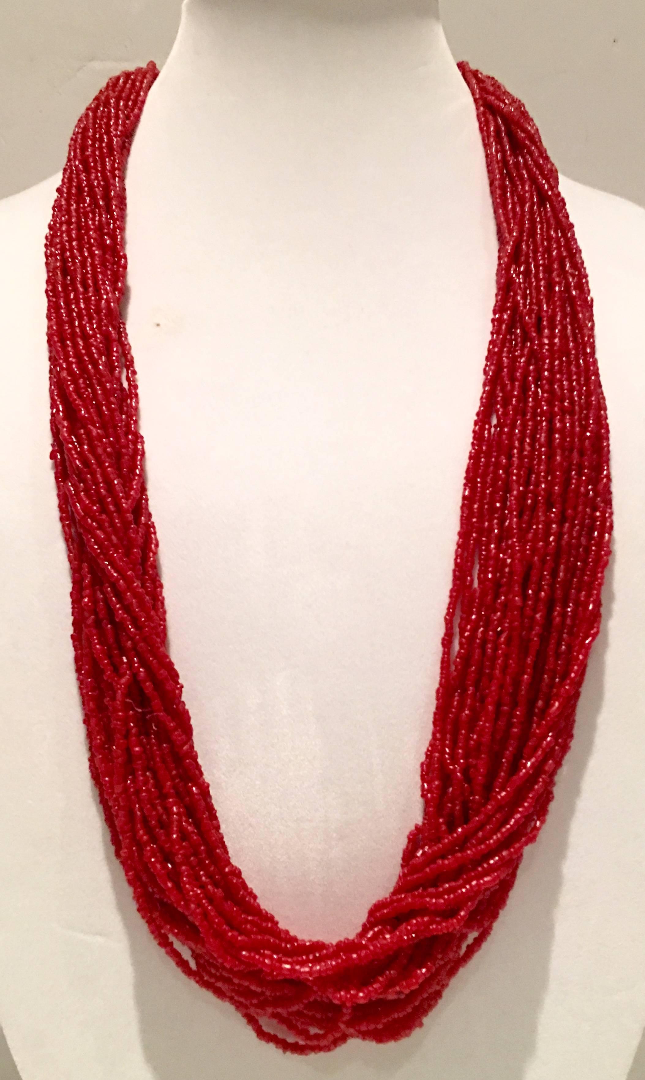 1970'S Navajo Style  red coral and sterling silver bead 30-strand necklace. This bold statement piece can be worn long or double up for a chunky choker style necklace.
