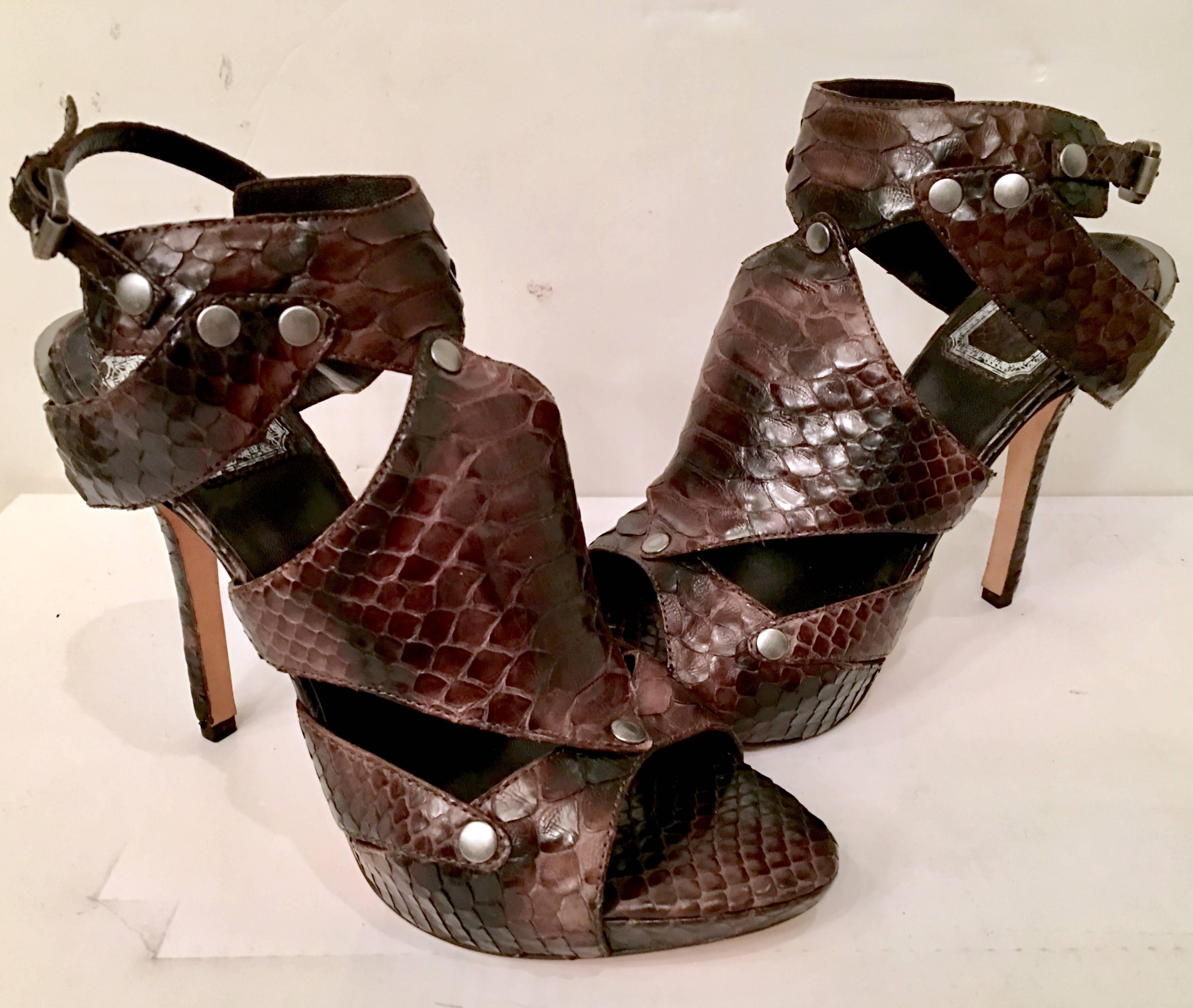 Contemporary Pair Of Christian Dior Python Gladiator Platform Sandals-Italy.
Finished in chocolate brown and black with pewter stud detail. Signed on the underside, DIOR  Made In Italy-.38.5.( 8.5 US) 
, These 5" inch high heel sandals were