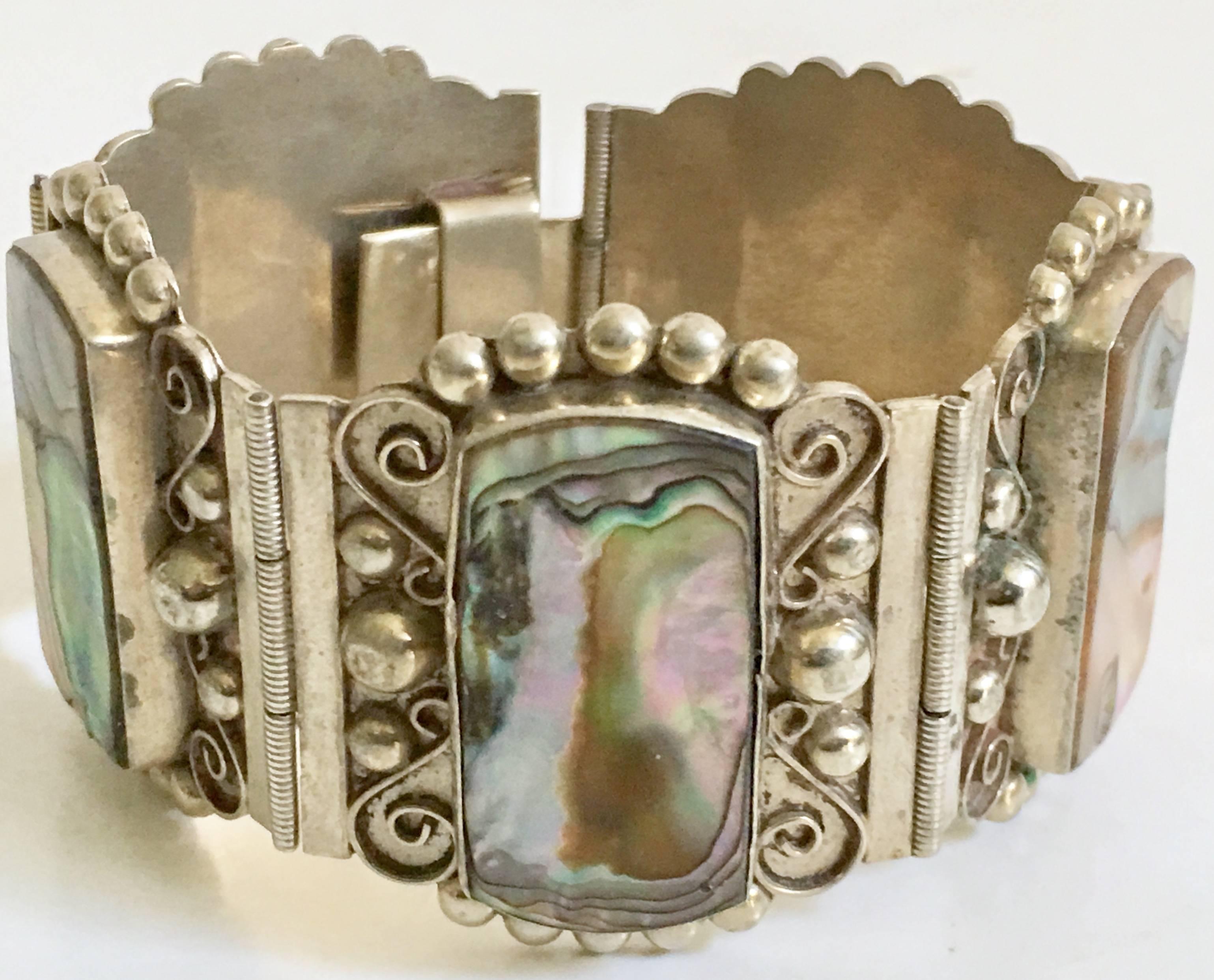 Mid-Century Taxco-Mexico Sterling Silver & Abalone Shell 5 Panel Bracelet, Signed. This exquisitely crafted piece of art has five panels with sterling silver bead and filigree work. Each panel has a raised bezel set abalone shell stone of