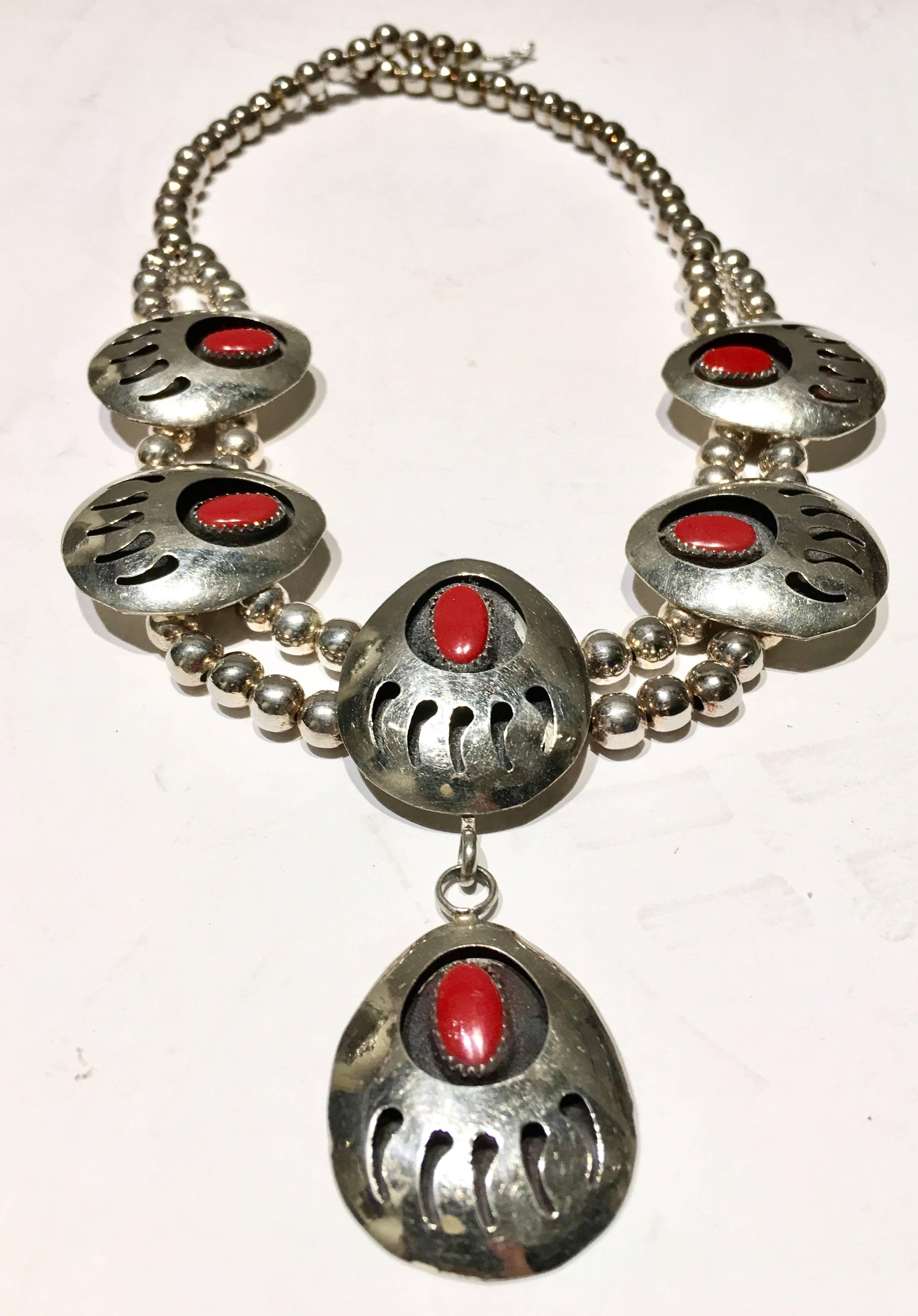 Vintage Native American style sterling silver and coral bear claw disc squash blossom necklace. Necklace features six discs in total. Each piece of coral is approximately 0.50
