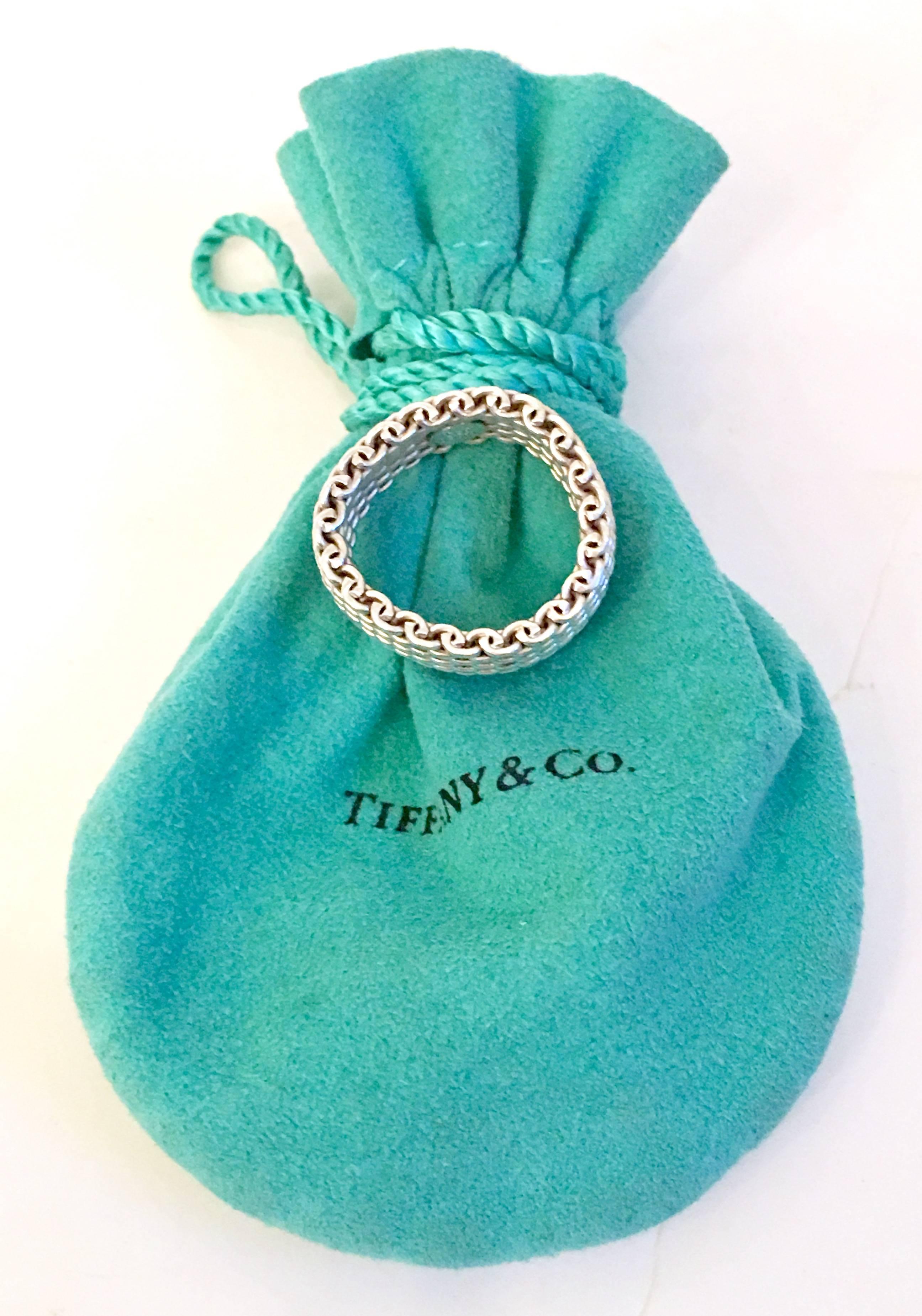 Contemporary Tiffany Sterling Silver 925 Mesh Ring with Tiffany Blue Pouch.  This iconic sterling mesh ring is a size 8.5 and has some flexibility to is. Included the original Tiffany blue anti tarnish protective draw string pouch. Marked Tiffany
