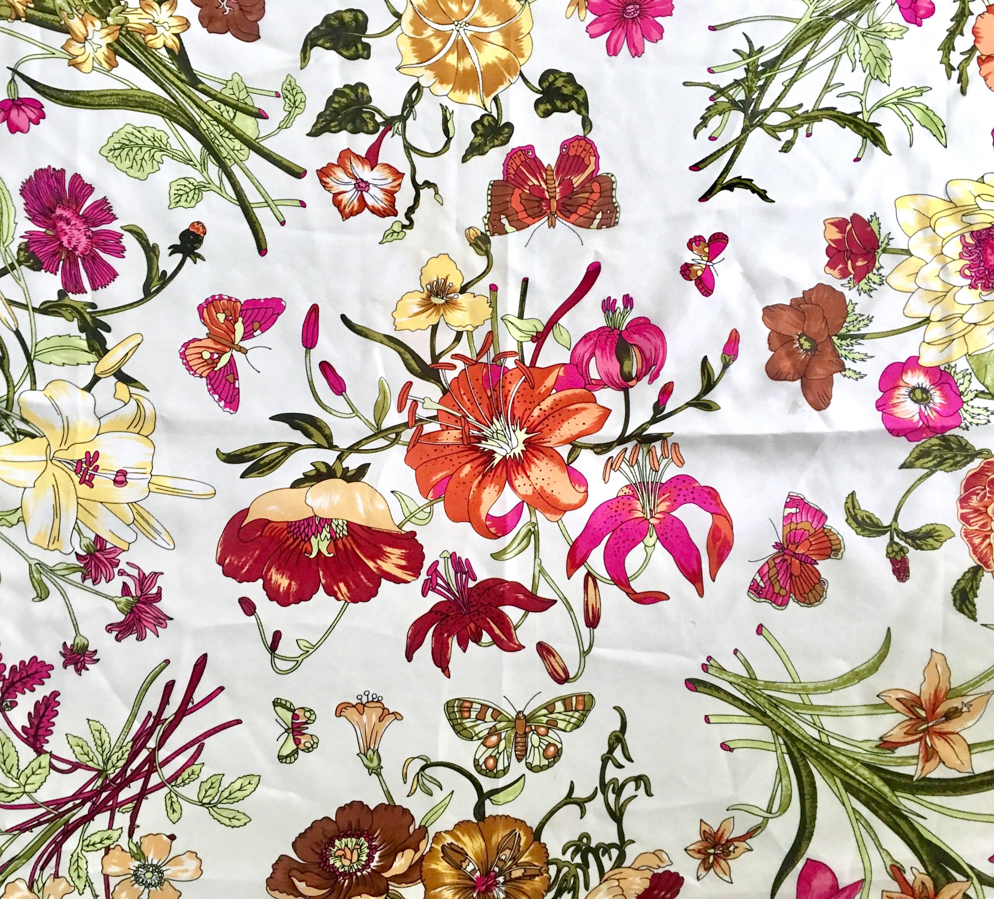 Vintage Gucci Style Marigold Floral Silk Scarf-Italy. Features the iconic Gucci style floral print on a white ground with hand rolled edge and marigold border. Manufacturers tag present and reads 100% silk, Made In Italy.
Size, 34" square.
