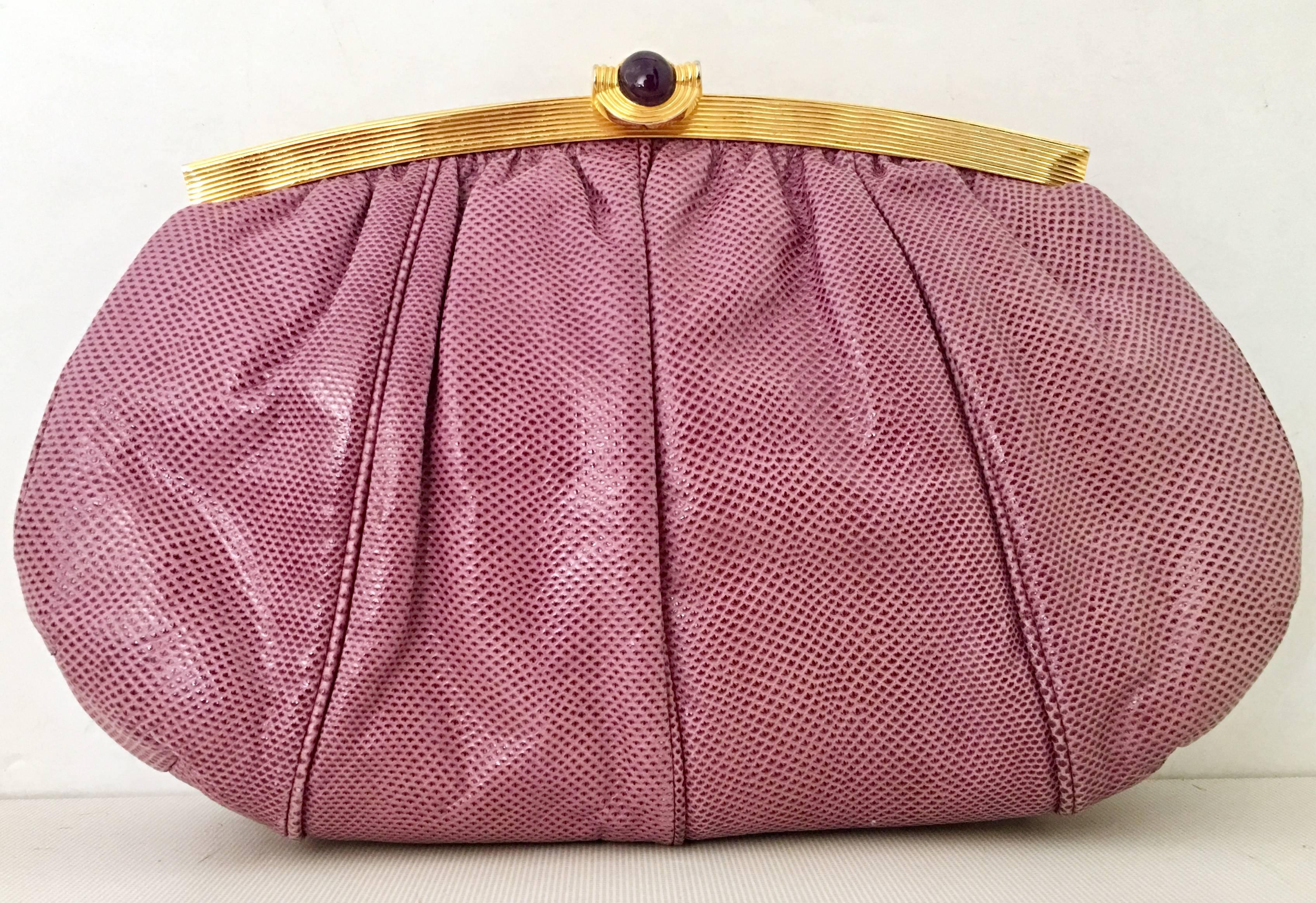 Vintage Judith Leiber Lavender Python & Gold Plate Amethyst Stone Hand Bag. This hand bag functions as a clutch or shoulder bag, features a gold plate frame and hardware with a amethyst stone at the snap claps. Includes a gold shoulder strap chain.