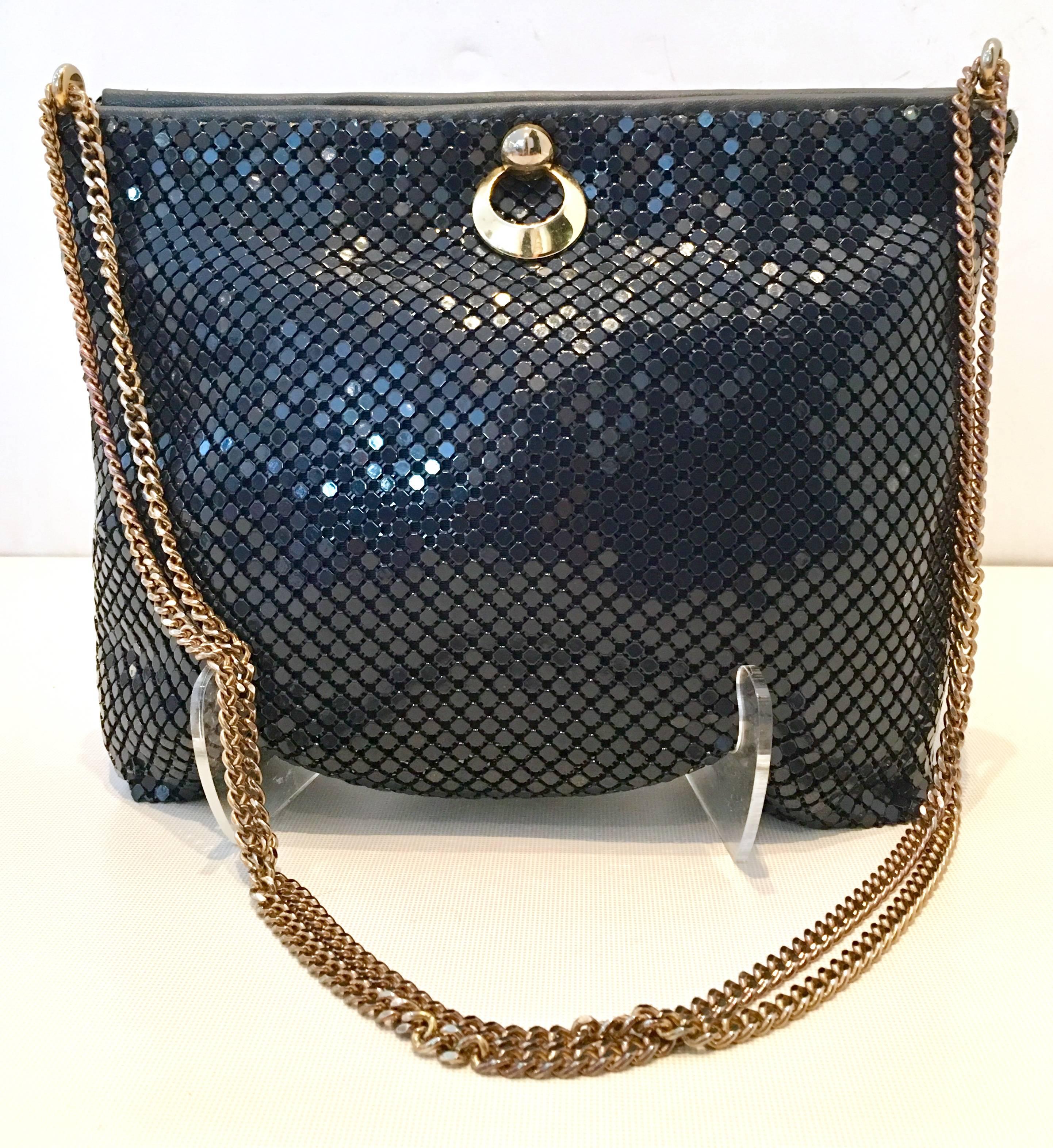 Vintage Whiting & Davis Navy & Gold Metal Mesh Shoulder Hand Bag. This rare navy hand bag features a god chain link adjustable double shoulder strap with accordion style open and close feature and gold tone snap closure hardware. The interior is