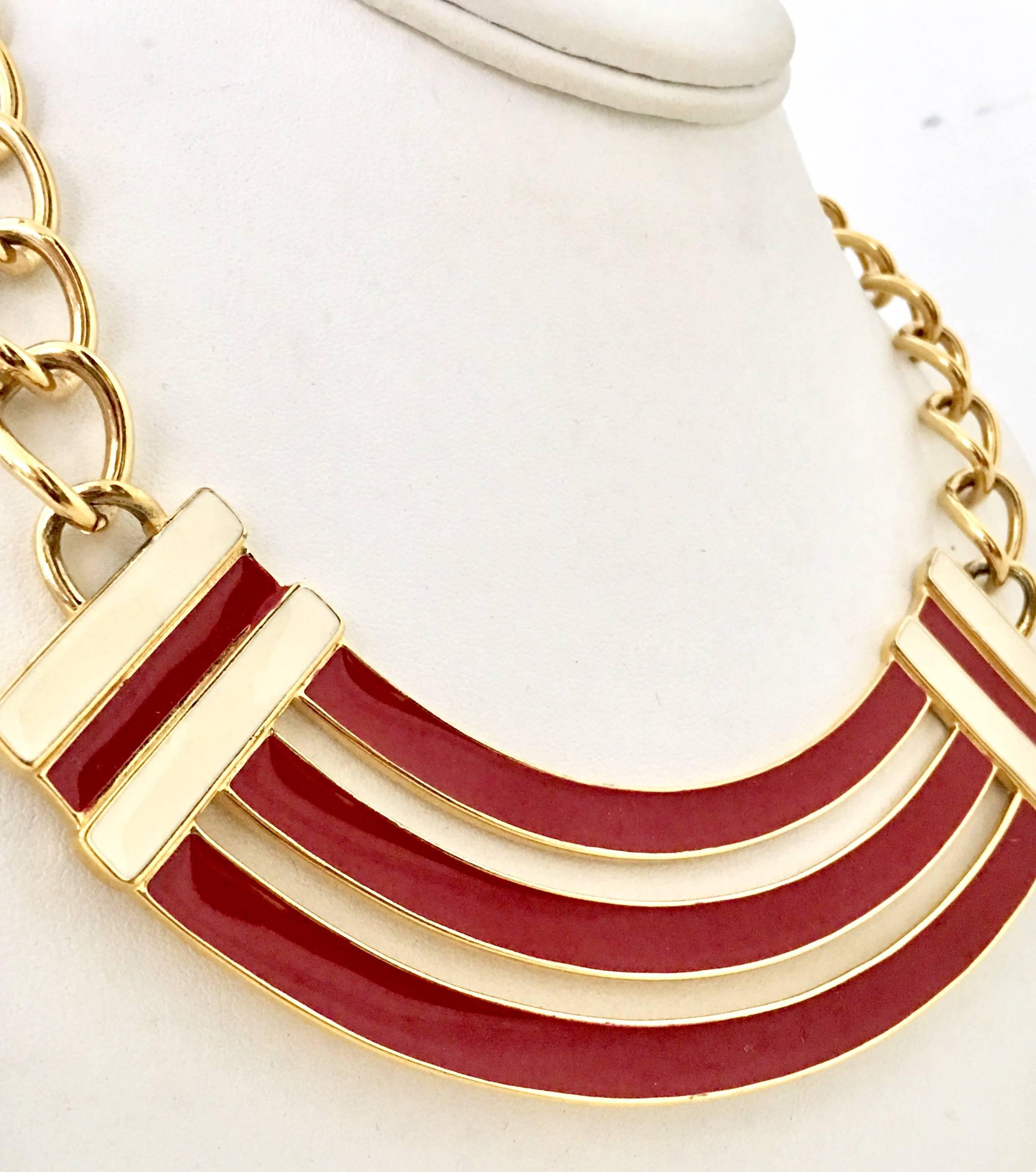 Vintage & Modern Gold Plate &  Off Red and white enamel Art Deco Style Curved Flat Bar Adjustable Choker Necklace. Signed on the underside, Monet. Adjustable hook style closure. Adjusts to choker style. Central ornament is 6