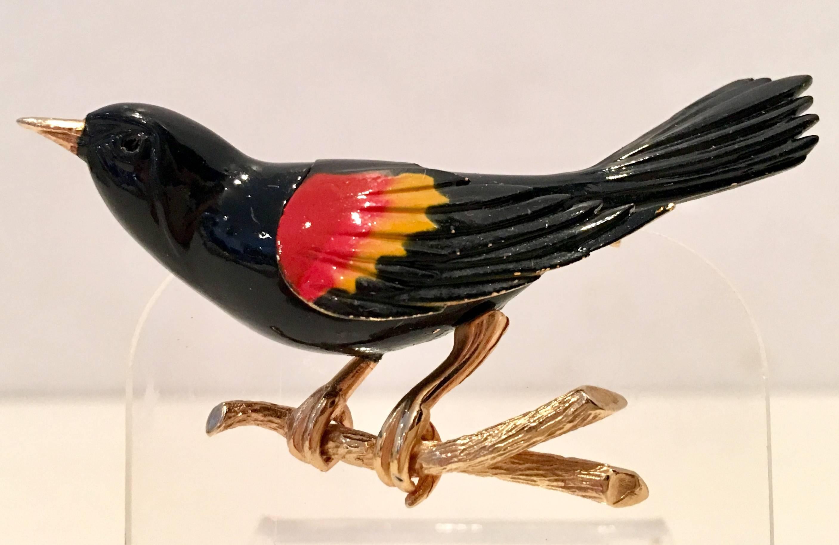 1960'S Gold plate & black enamel Bird Perched On A Branch brooch By, Weiss. Executed in black orange and yellow enamel perched on a branch and finished with gold plate. This bird brooch is signed on the underside, Weiss.