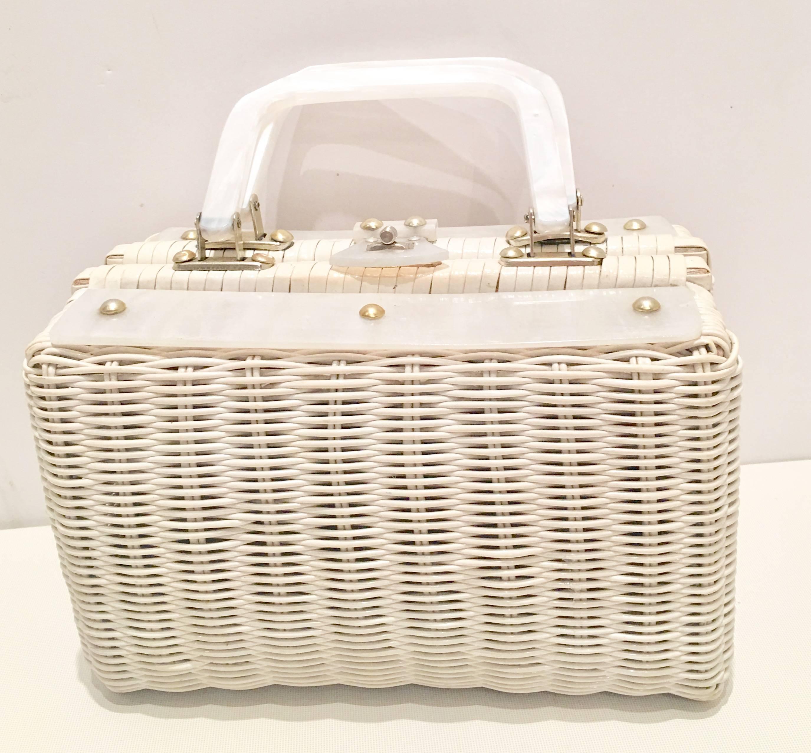 Vintage white woven and Lucite with brass hardware box style handbag. Lucite is white mother-of-pearl finish. Interior is lined with a storage pocket and has the original manufacturer tag that reads, Hong Kong. Lucite handles have a 4" inch