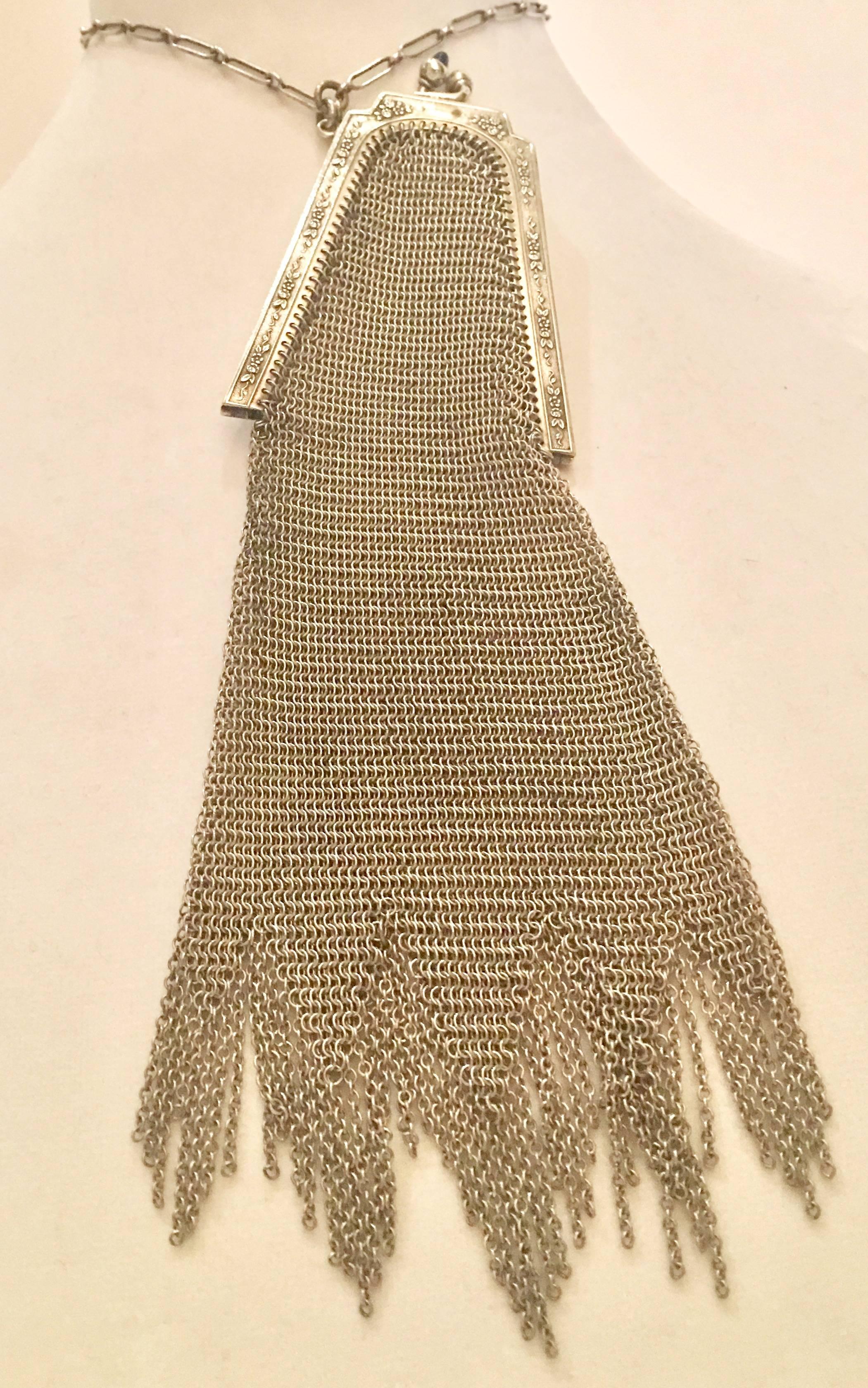 Rare Early 1900'S collectors signed Whiting & Davis Sterling Silver mesh flapper bag wristlet. Incredible delicate and always sturdy this Whiting & Davis flapper handbag features a beautiful Venetian fringe bottom, floral frame scroll work,