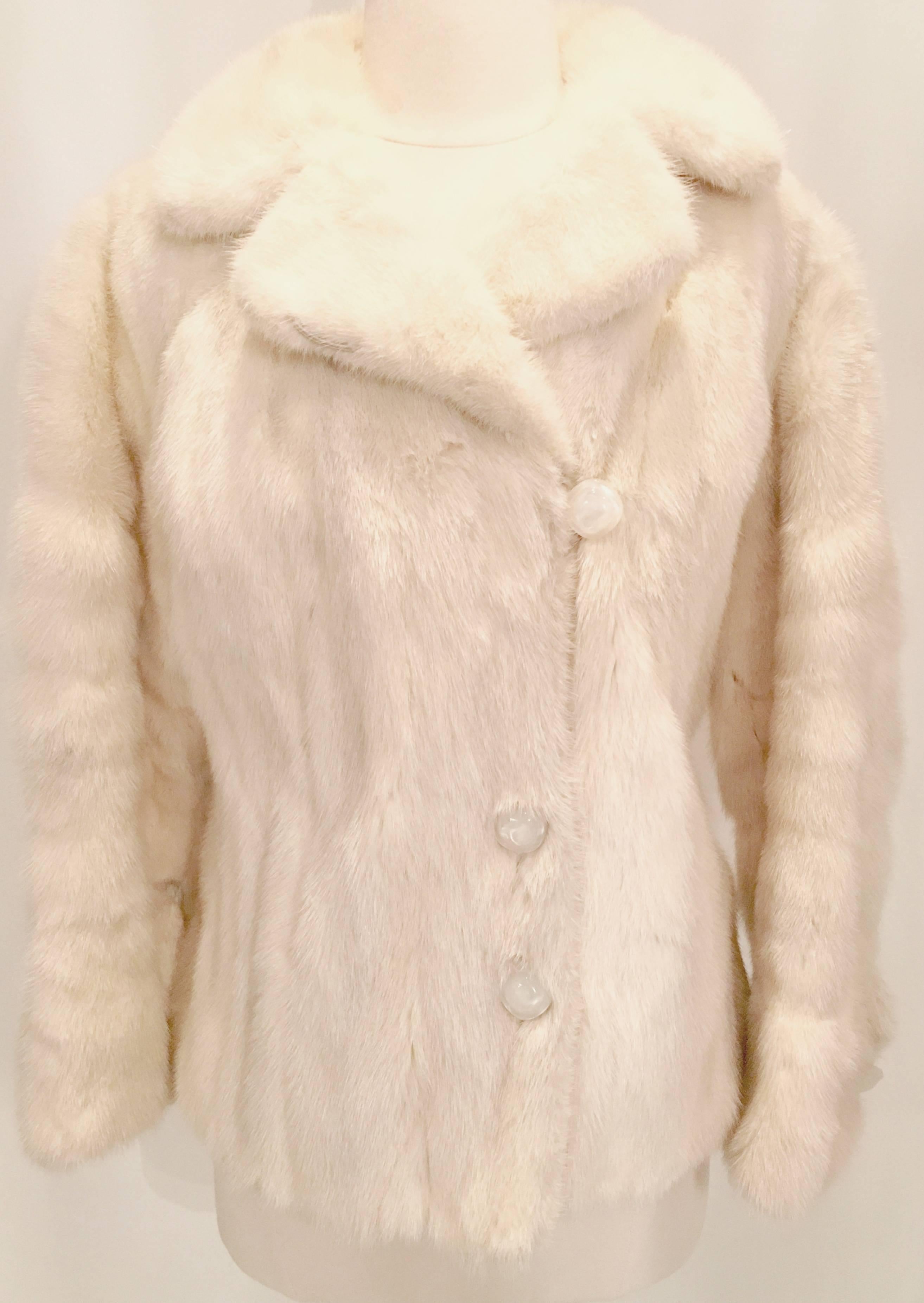 1970'S designer Oleg Cassini winter white mink fur jacket with "bling" details. Classic pea coat style with added pizzazz, bell sleeves at the wrist, peter pan style collar, milky white marbleized square rounded Lucite buttons and a built