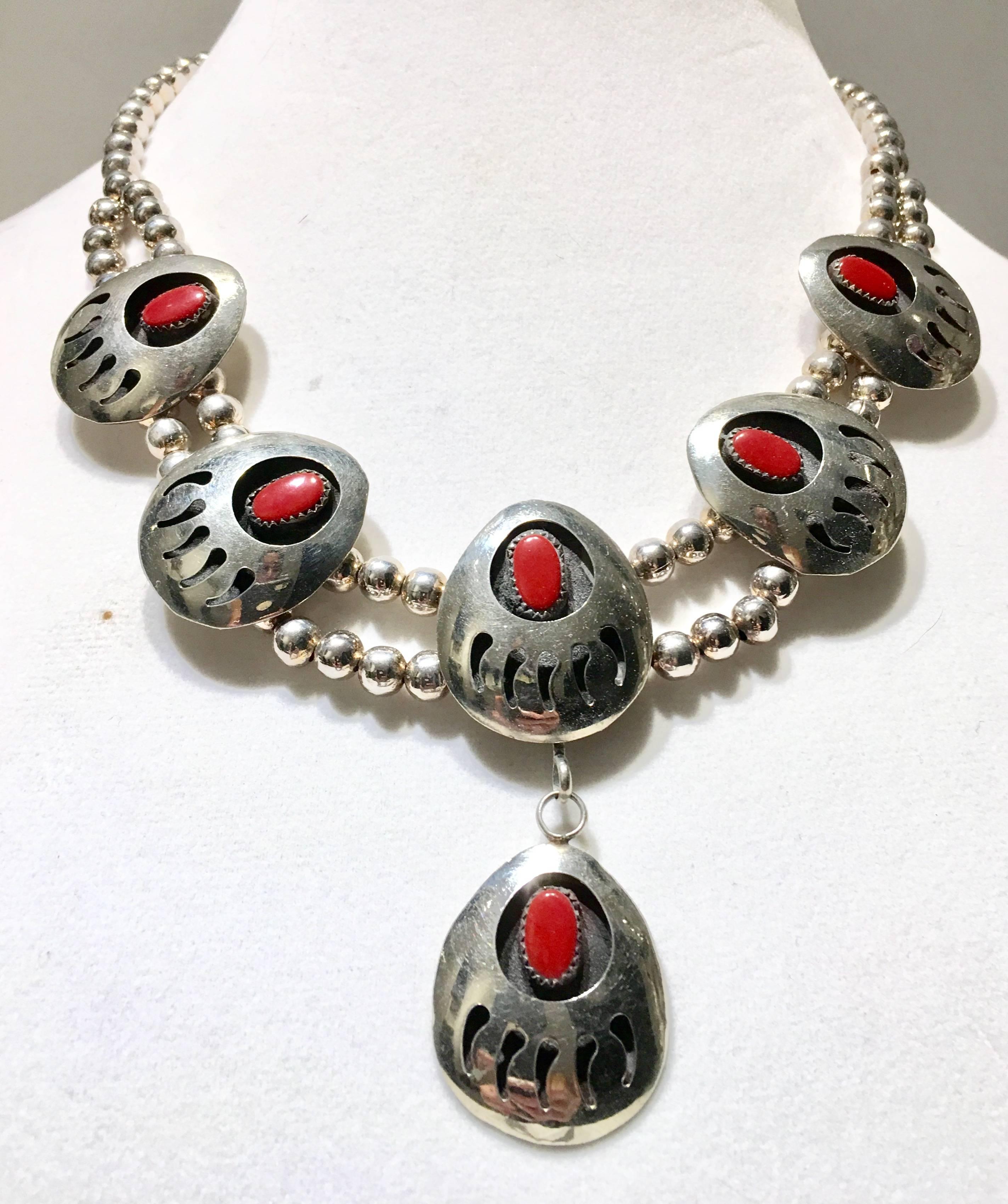 Unique Mid-Century Navajo sterling silver and coral bear claw disc squash blossom necklace. Necklace features six discs in total. Measures: Each piece of coral is approximately, .50" inches diameter. Each sterling silver bead is approximately