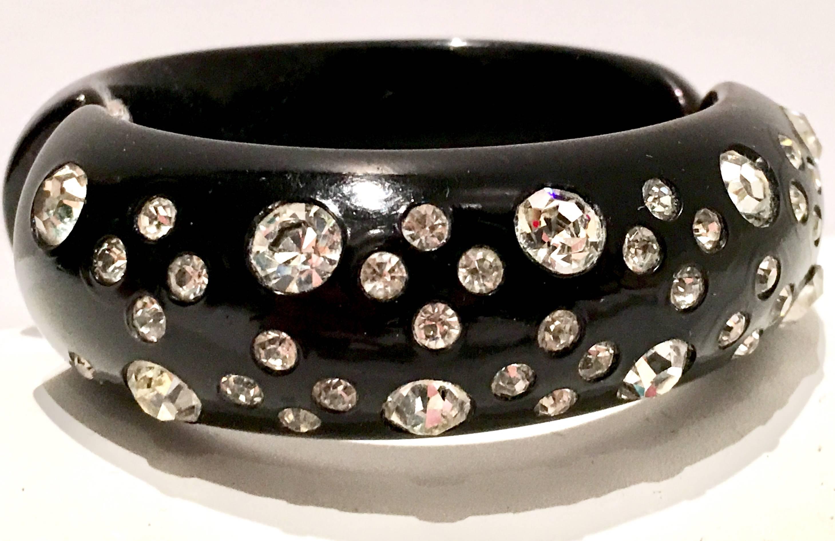 Rare Weiss Signed Black Thermoplastic & Austrian Crystal Clear Rhinestone Clamper Bracelet by, Weiss. This piece is signed on the chrome metal hinge interior, Weiss.
Internal diameter measures, 2