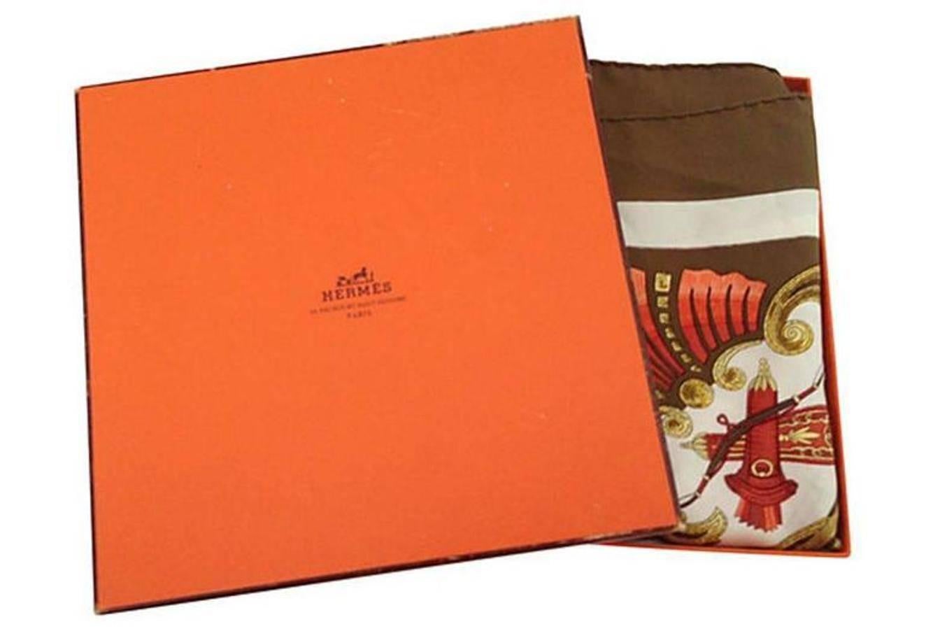 Hermès 100% silk scarf "Cheval Turc" scarf. Measures: 35" square. Designed for Hermes by, Christiane Vauzelles in 1969 This gorgeous equestrian theme scarf features a man with a turban leading a horse with a brown ground and coral,