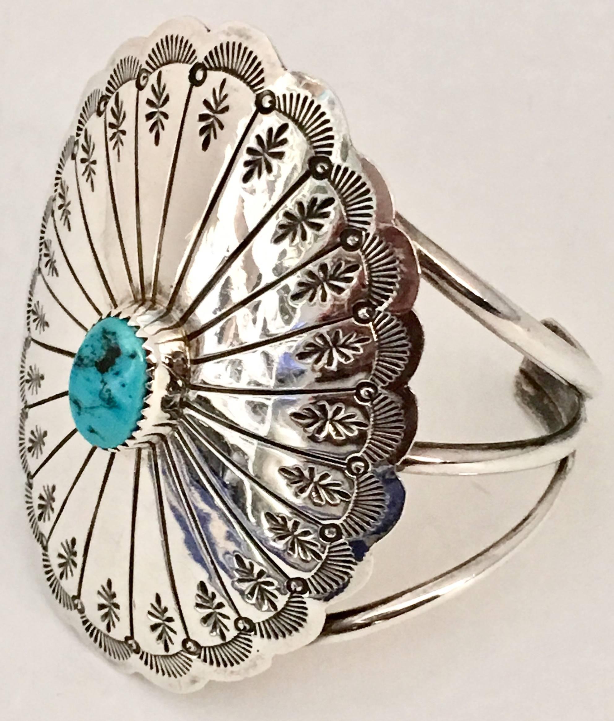 Mid-Century Classic Navajo sterling silver and single turquoise stone triple strand cuff bracelet. This cuff features Native American sun symbols and a single oval cabochon set turquoise stone. Singed on the backside, sterling. Turquoise stone