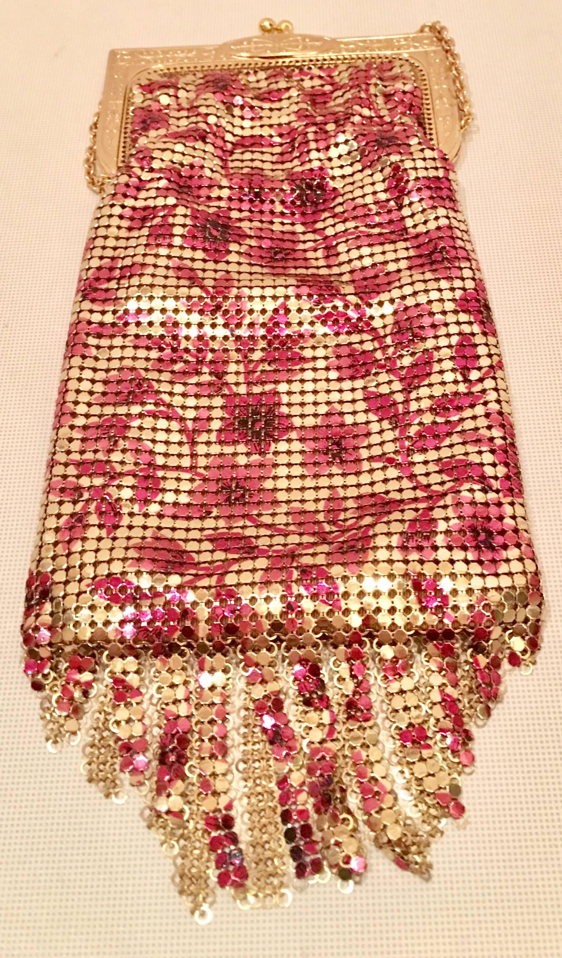 Whiting & Davis Art Deco style gold and ruby metal mesh floral motif 110th anniversary "Heritage" flapper bag. Features a fringe detail bottom and chain link shoulder strap. This bag is new and never before used and includes the