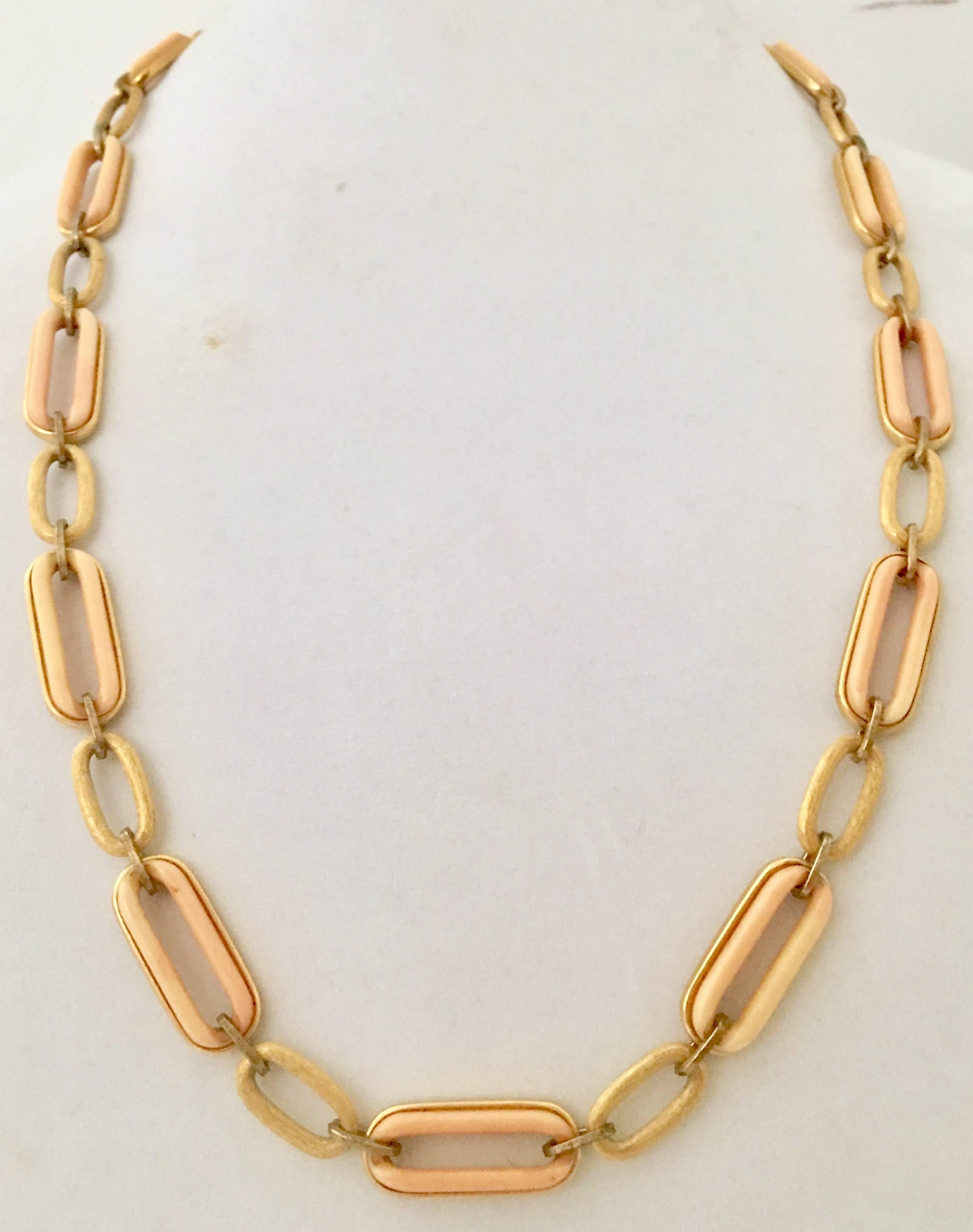 Vintage Givenchy chain link opera length necklace of peach Lucite inlay and brushed gold plate.Can be doubled up to choker length. Clasp is a double GG signed Givenchy box style clasp.
