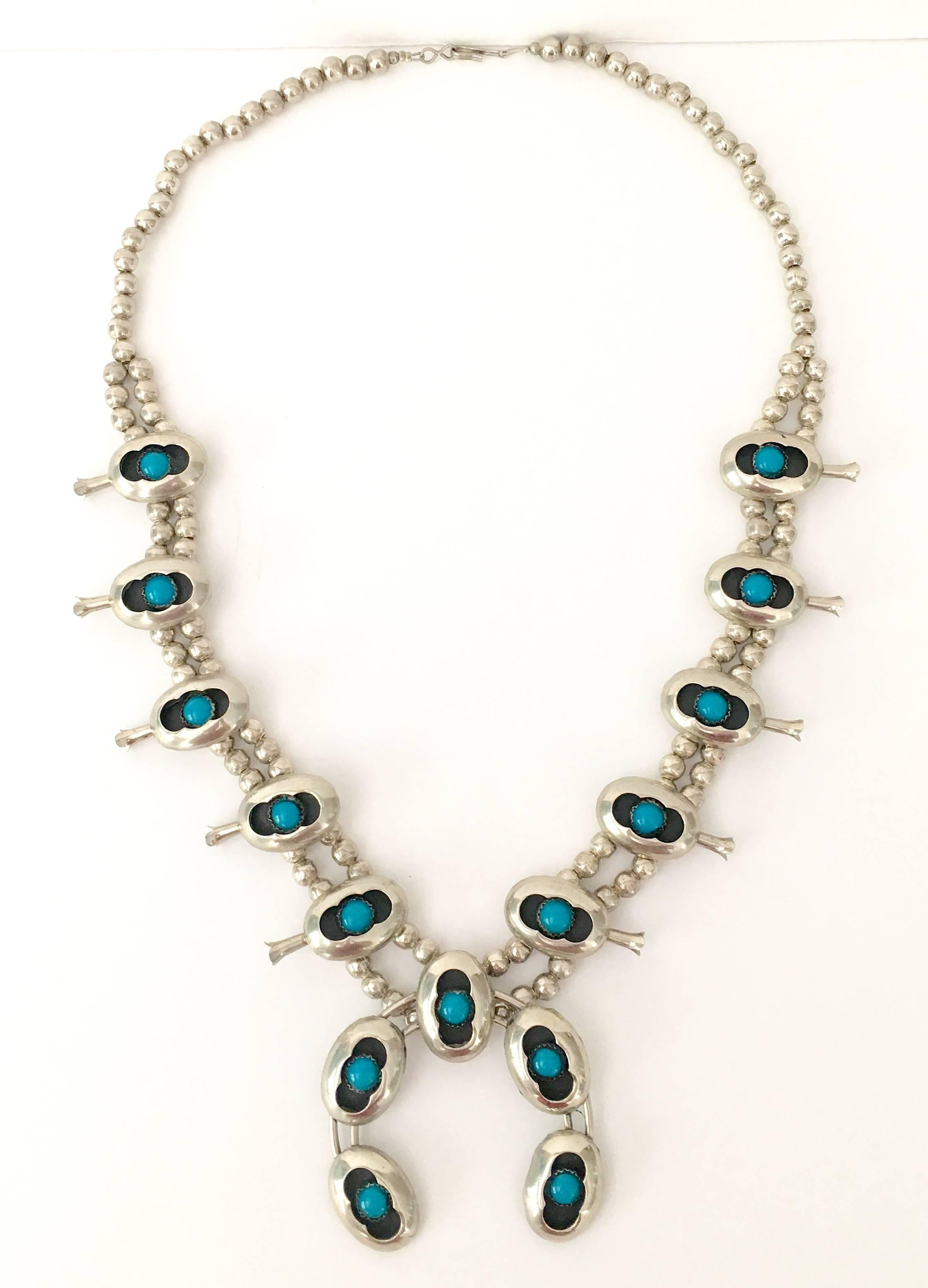Vintage Navajo sterling silver and turquoise shadow box set Naja squash blossom necklace. 15 quarter inch turquoise stone throughout. Ten small "Naja" and one large center "Naja" on a double sterling silver bead necklace. The