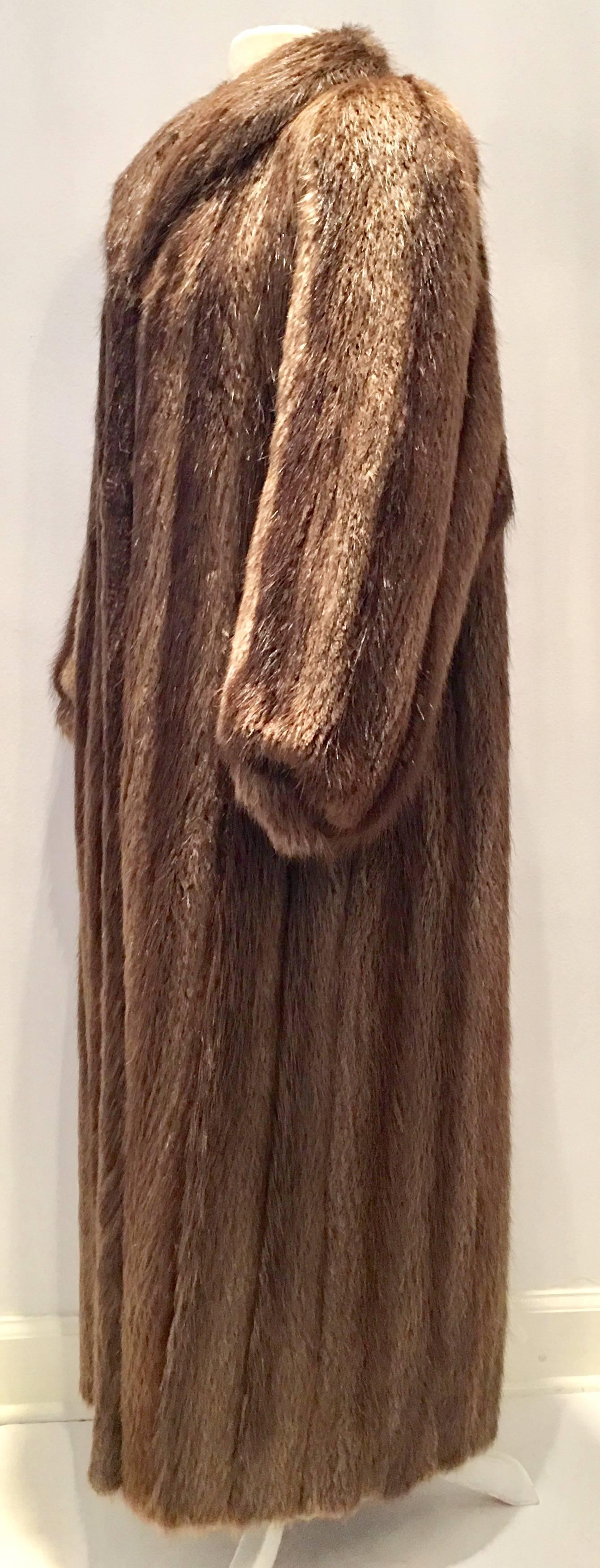 1990'S fine long hair beaver fur full length coat. Semi-aquatic builder of dams, the beaver is one of the warmest natural furs available on the market. Beaver is the best fur to recycle, perhaps into a home accessory item or retrofitted into an