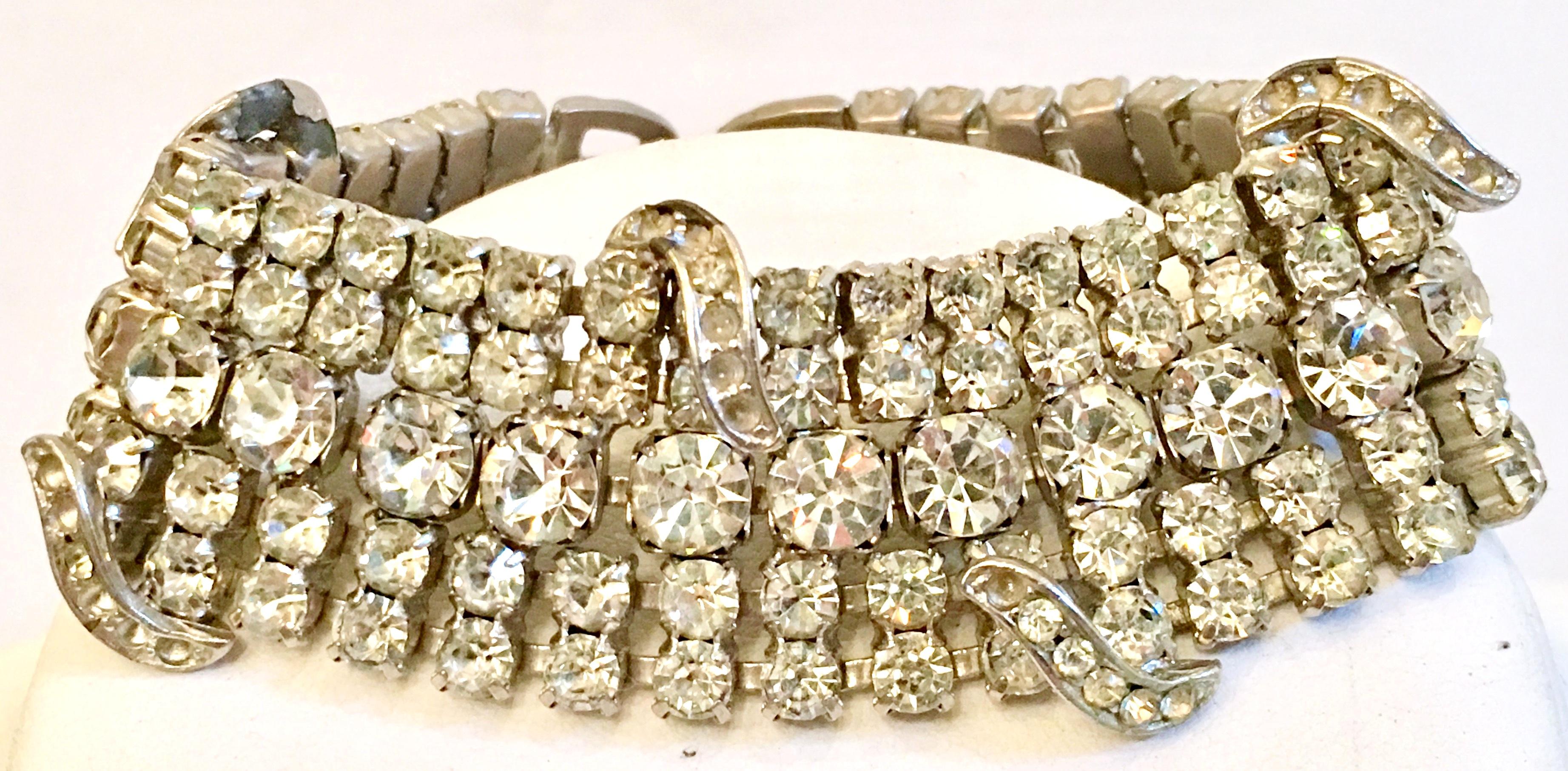 20th Century  Art Deco Silver Pot Metal & French Paste Crystal Clear Rhinestone Bracelet. This substantial bracelet features curved and raised over mount detail, jeweled fold over box clasp and safety chain.