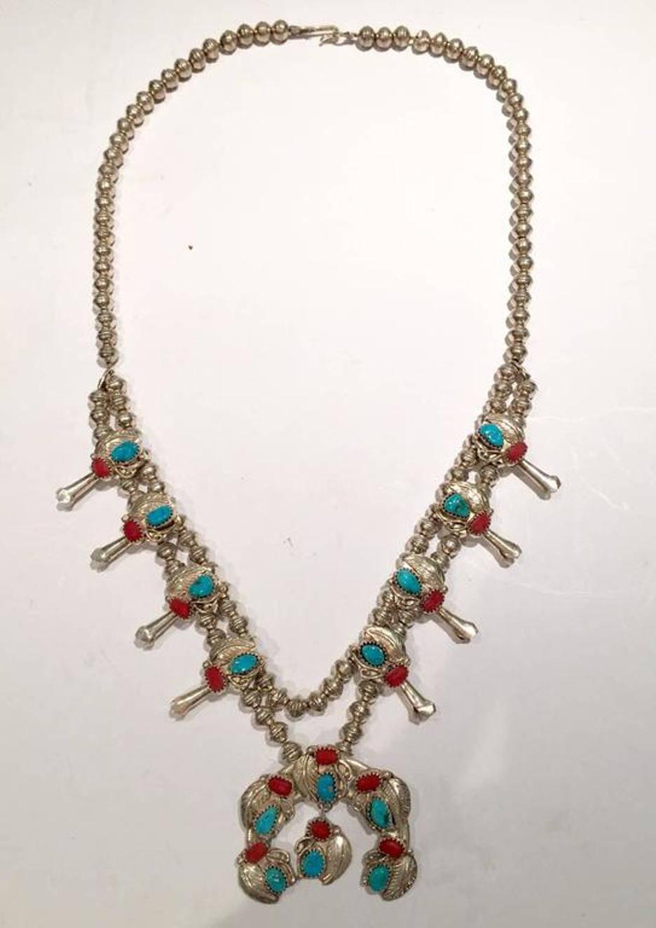 Vintage Native American-style double-sterling silver bead, turquoise, and coral squash blossom necklace. This piece is set with a total of 28 semi-precious stones: 14 turquoise and 14 coral. Each stone is approximately .25"Dia. Each sterling