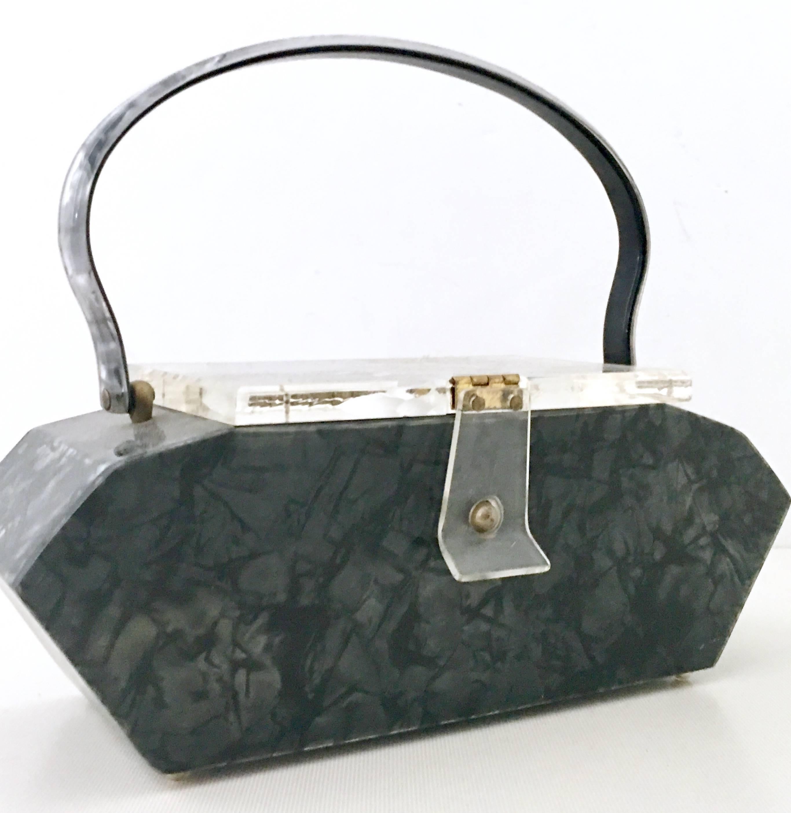 1940'S Art Deco Carved & Marbleized Gun metal Grey Lucite Box Purse By, Nelson Originals Miami Fla. This box style top hand purse features a carved floral motif transparent hinge lid with flap closure, gunmetal grey body and handle with brass