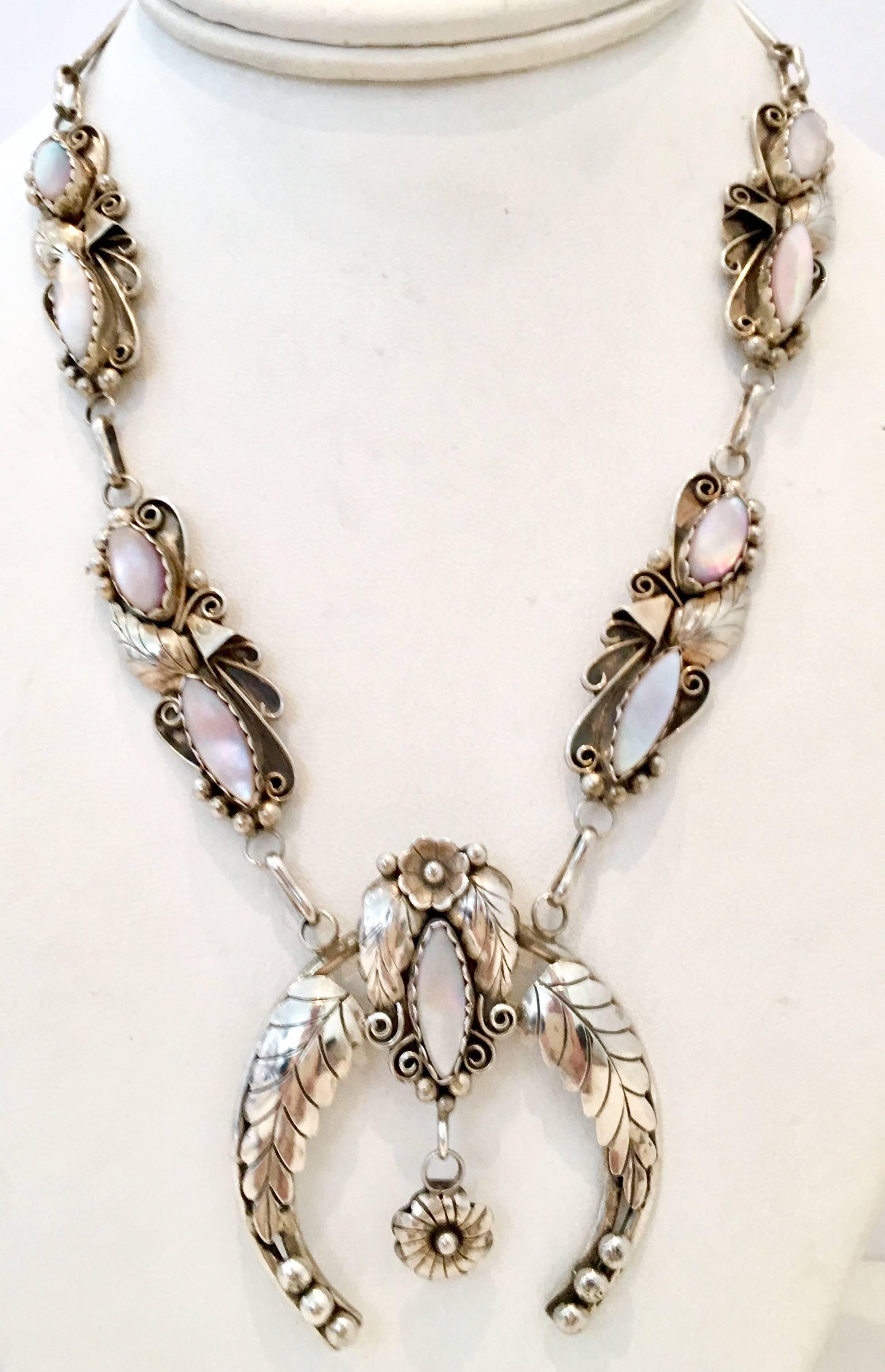 1970'S Navajo Sterling Silver & Pink Mother Of Pearl Squash Blossom Necklace By, Angela Lee. This unique choker length squash blossom necklace features nine mother of pearl stones bezel set in a intricately detailed sterling silver raised bead and