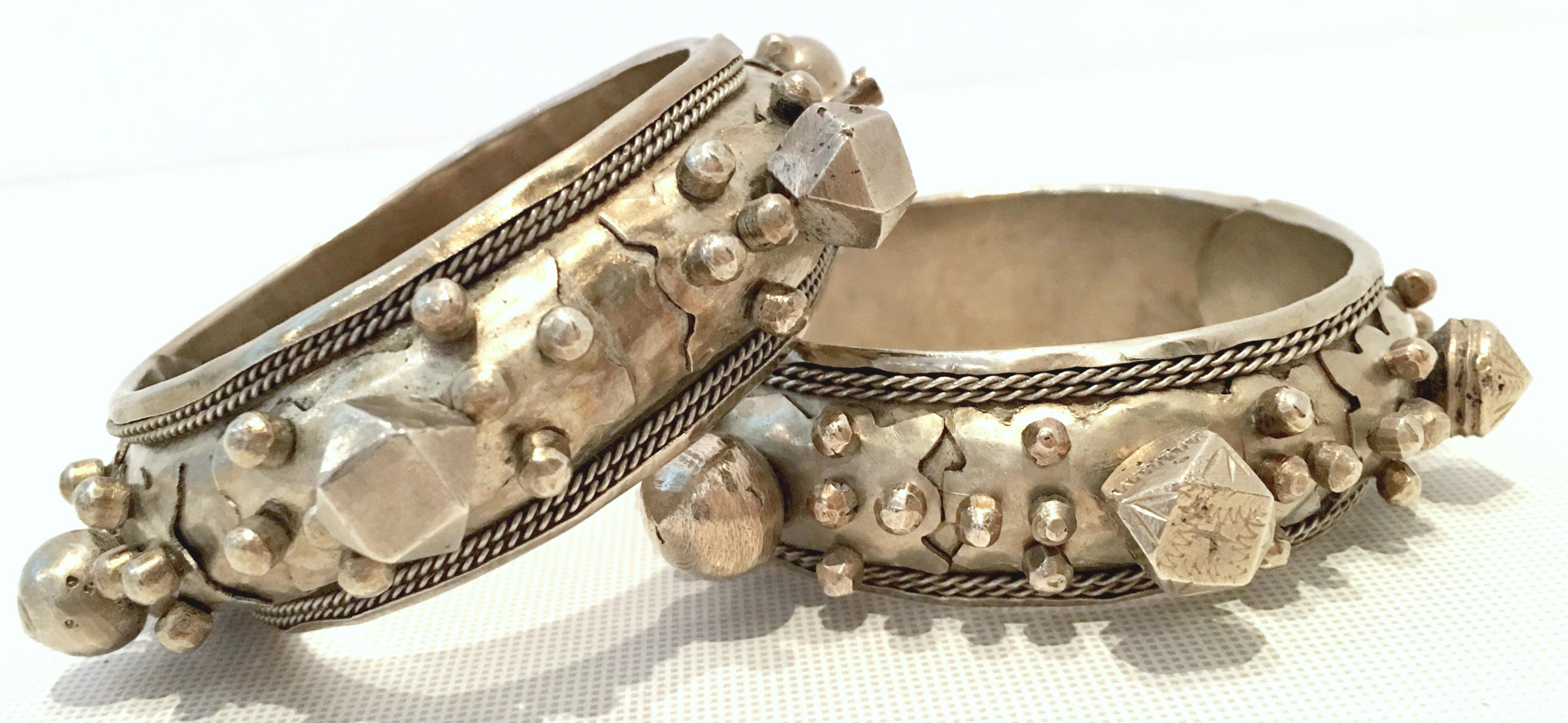 Mid-20th Century Rare Pair Of Old Silver Rajasthan Tribal Style Clamper Bangle Bracelets. These finely crafted and chunky bracelets feature a geometric raised and applied carved pattern. This pair of for the most part, identical bracelets have a