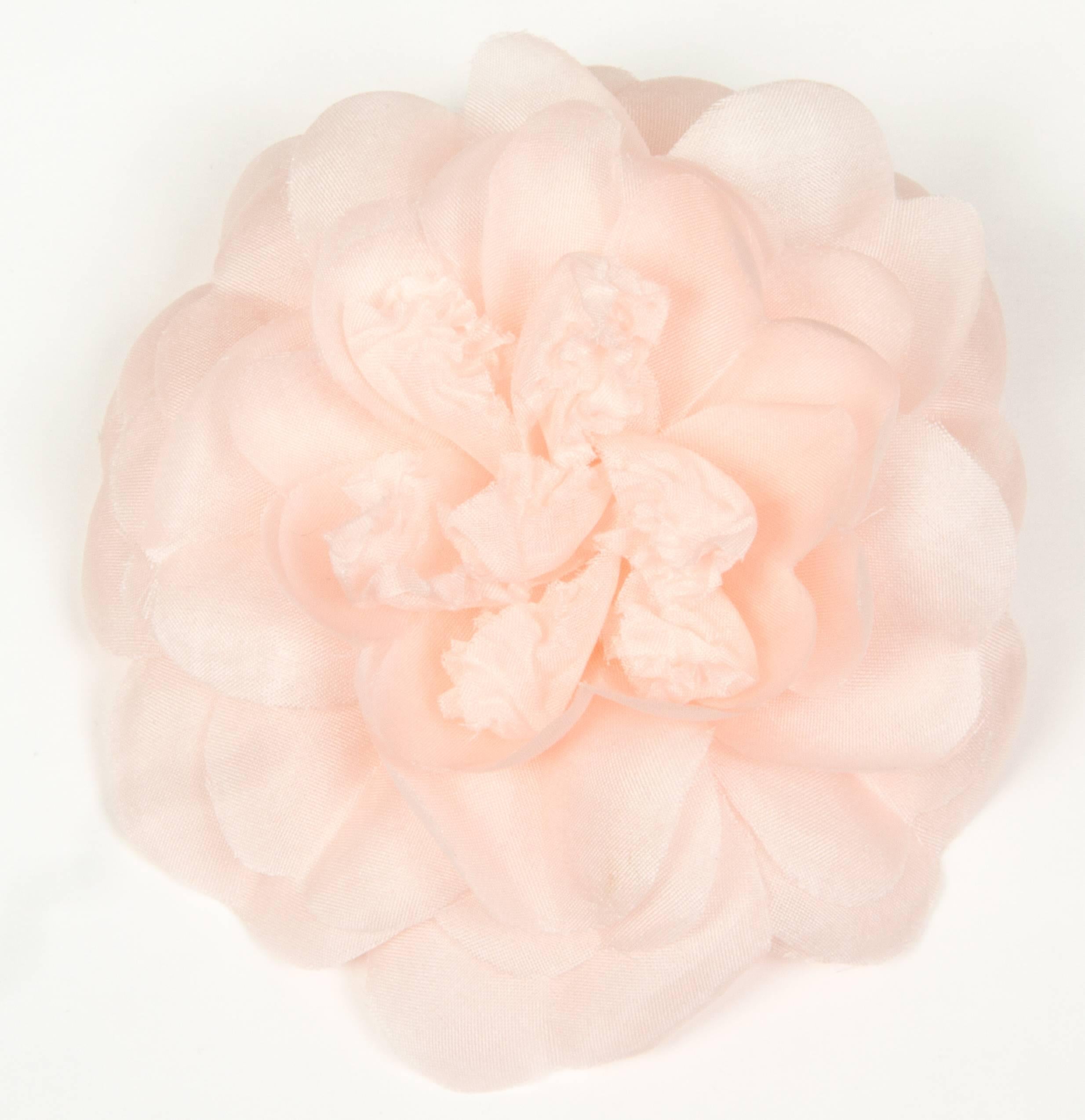This is a lovely soft pink camellia brooch.