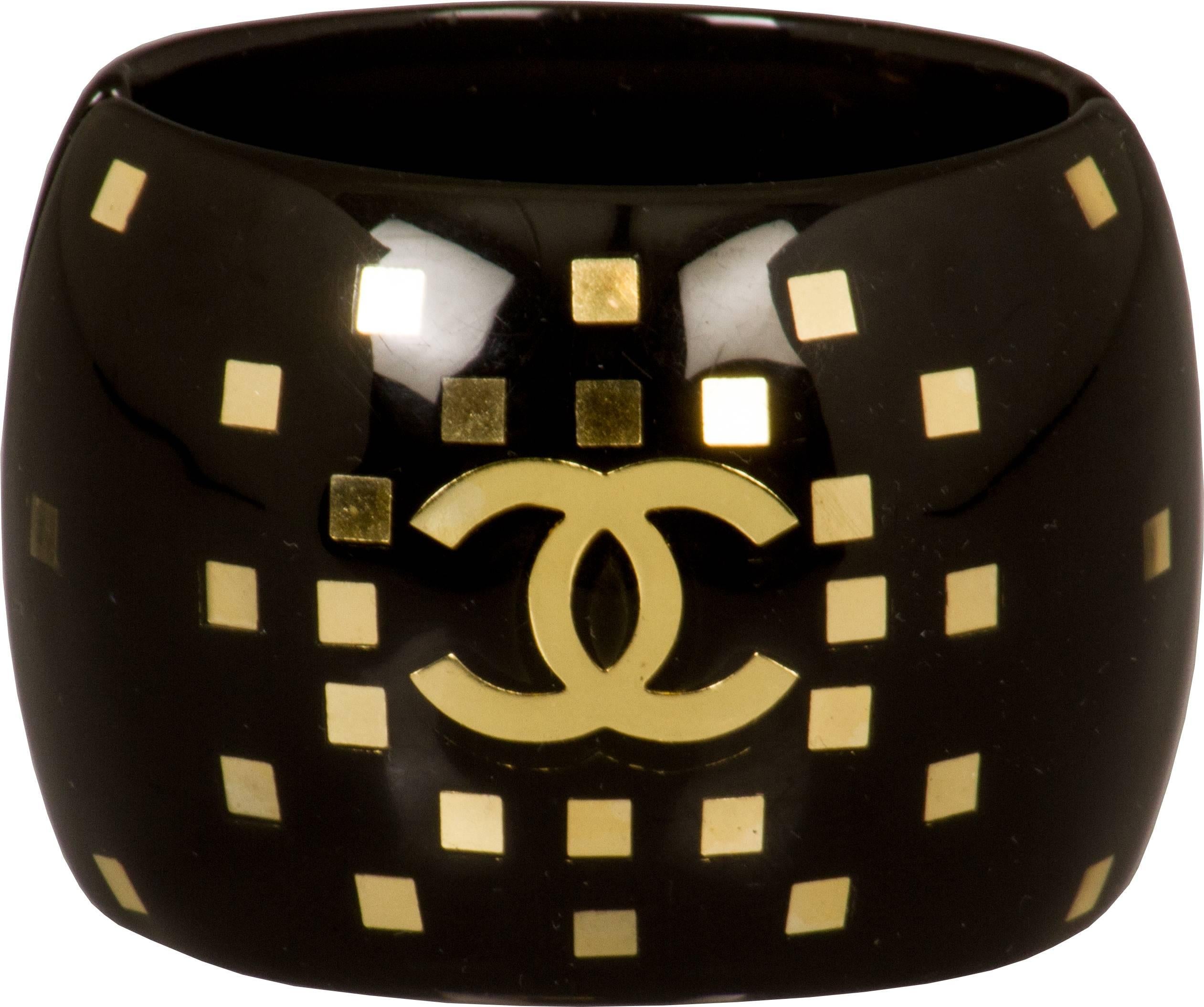 This is a handsome CHANEL logo bracelet accented with gold dating  to the Autumn 2001 collection.