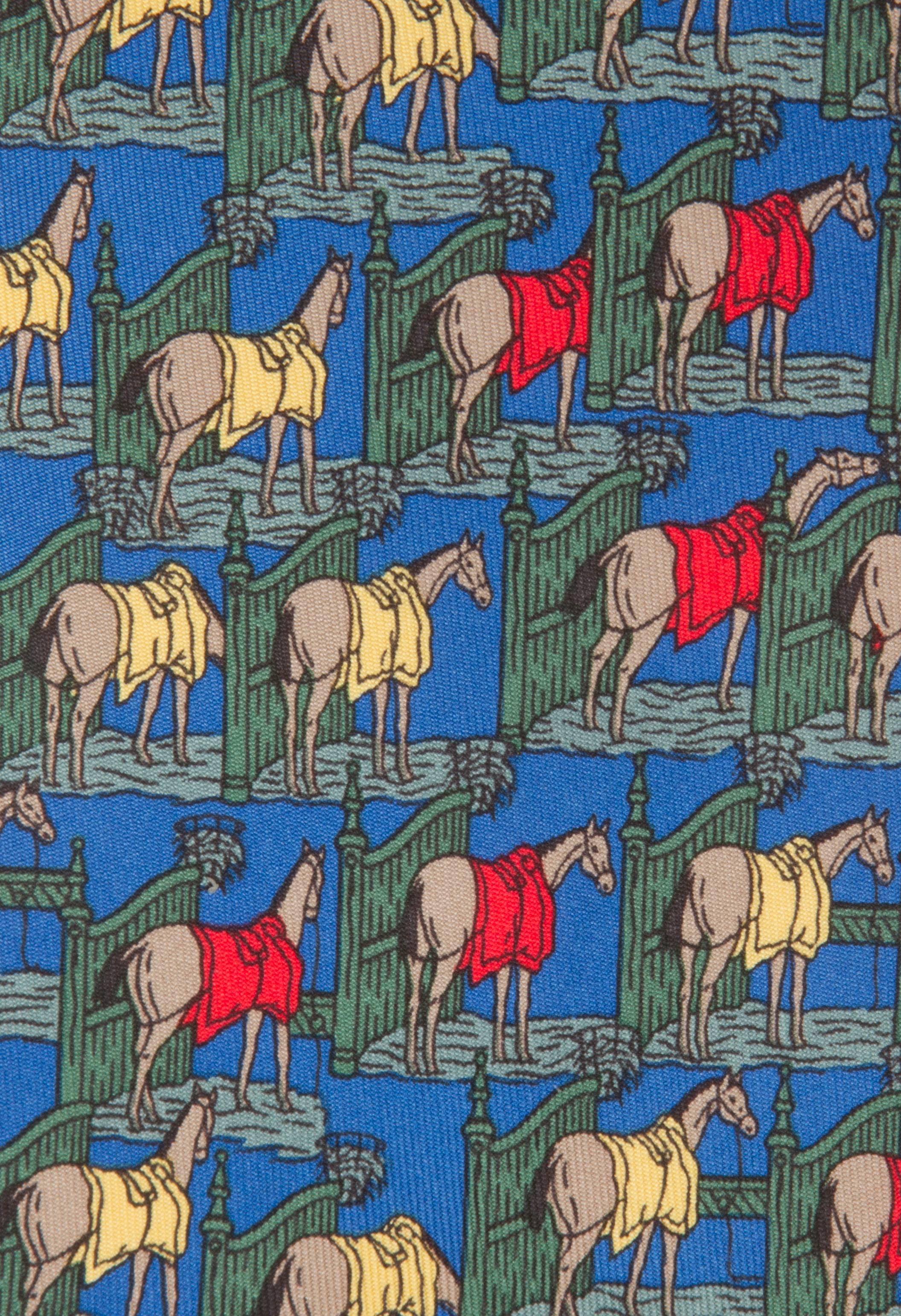 A wonderful yellow and red blanketed horsey tie on a blue background.