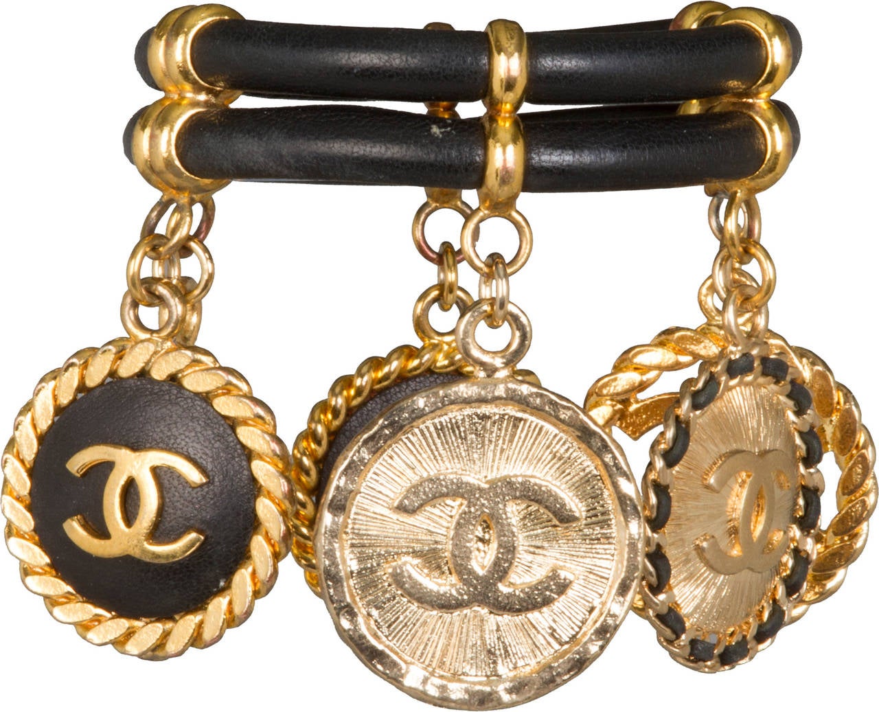 This rare  and fabulous bracelet has six variations of the CHANEL logo which hang from double black leather bands.

The internal circumference of the bracelet is 7.5