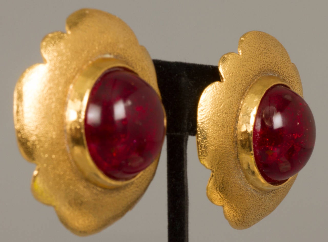 These are good looking earrings with poured glass cabochons in a cherry amber color.