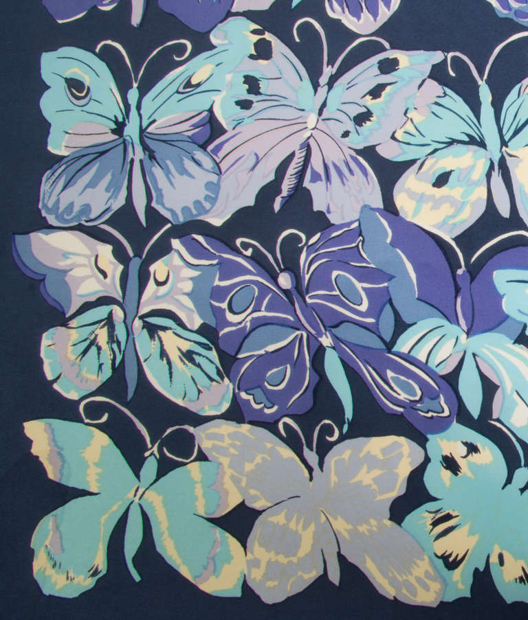 This is a whimsical yet sophisticated scarf with an overall butterfly motif apparently designed after Raoul Dufy. There is a very small pull and an even smaller stain, both in an unnoticeable place.