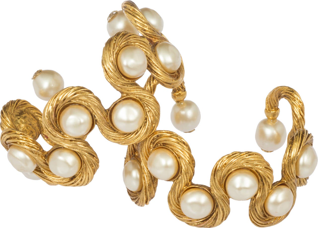 These are  great cuffs, having an undulating rope design studded with pearls. They will fit up to a 6.625