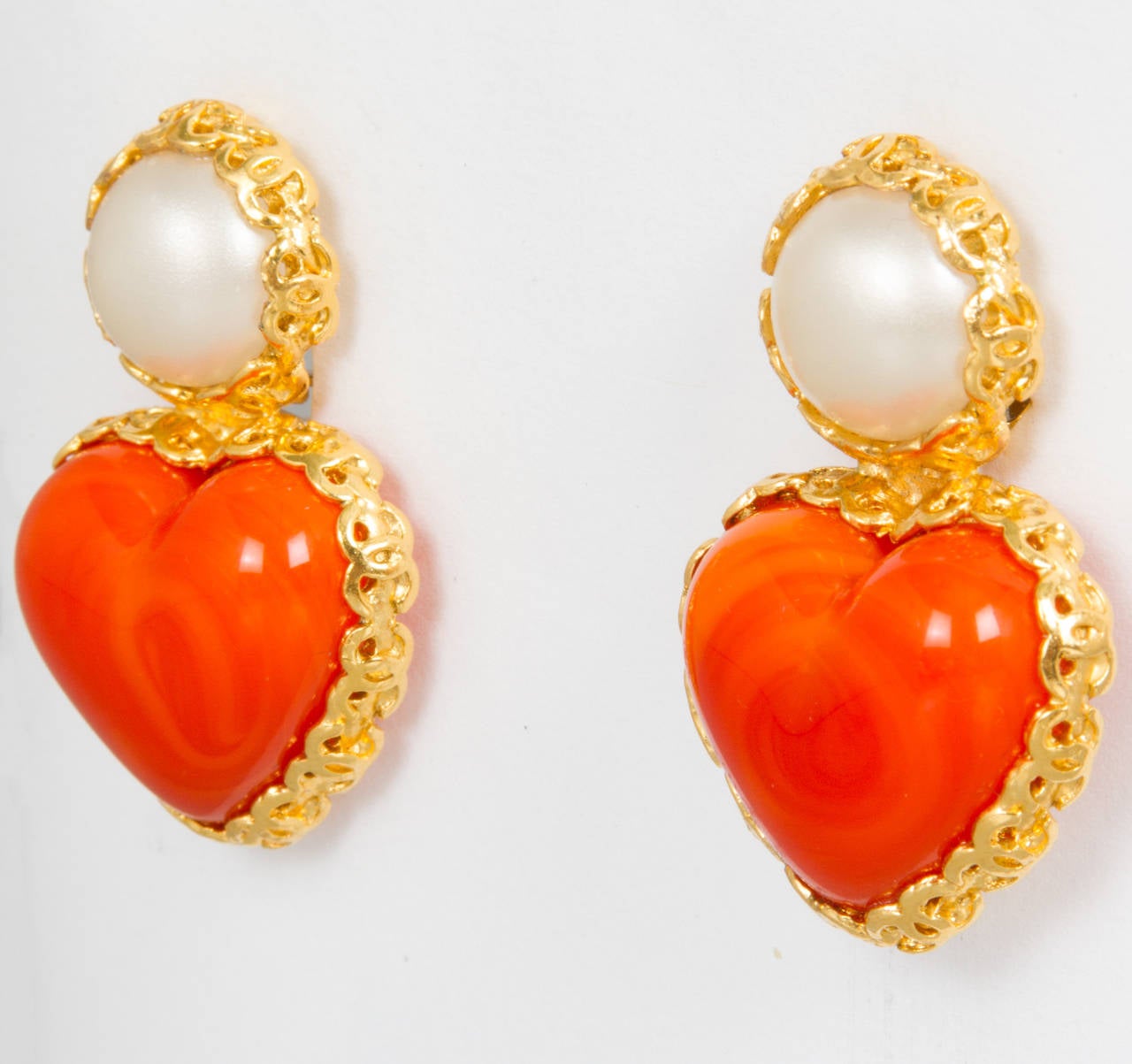 These are a nice wearable pair of earrings. Love the orange and pearl combination.